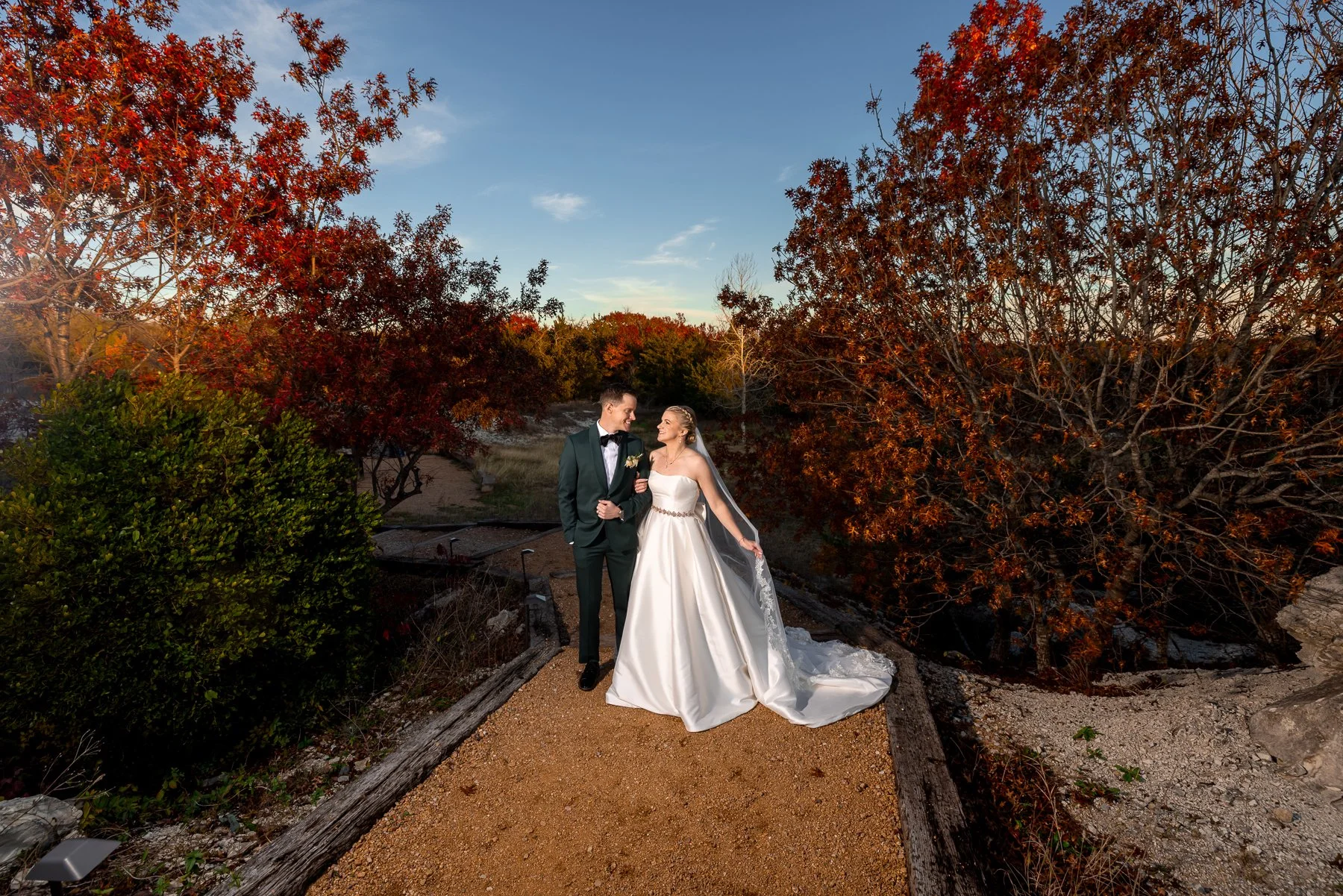 Bride and groom walking together during their Stone Crest Venue wedding in McKinney, TX.