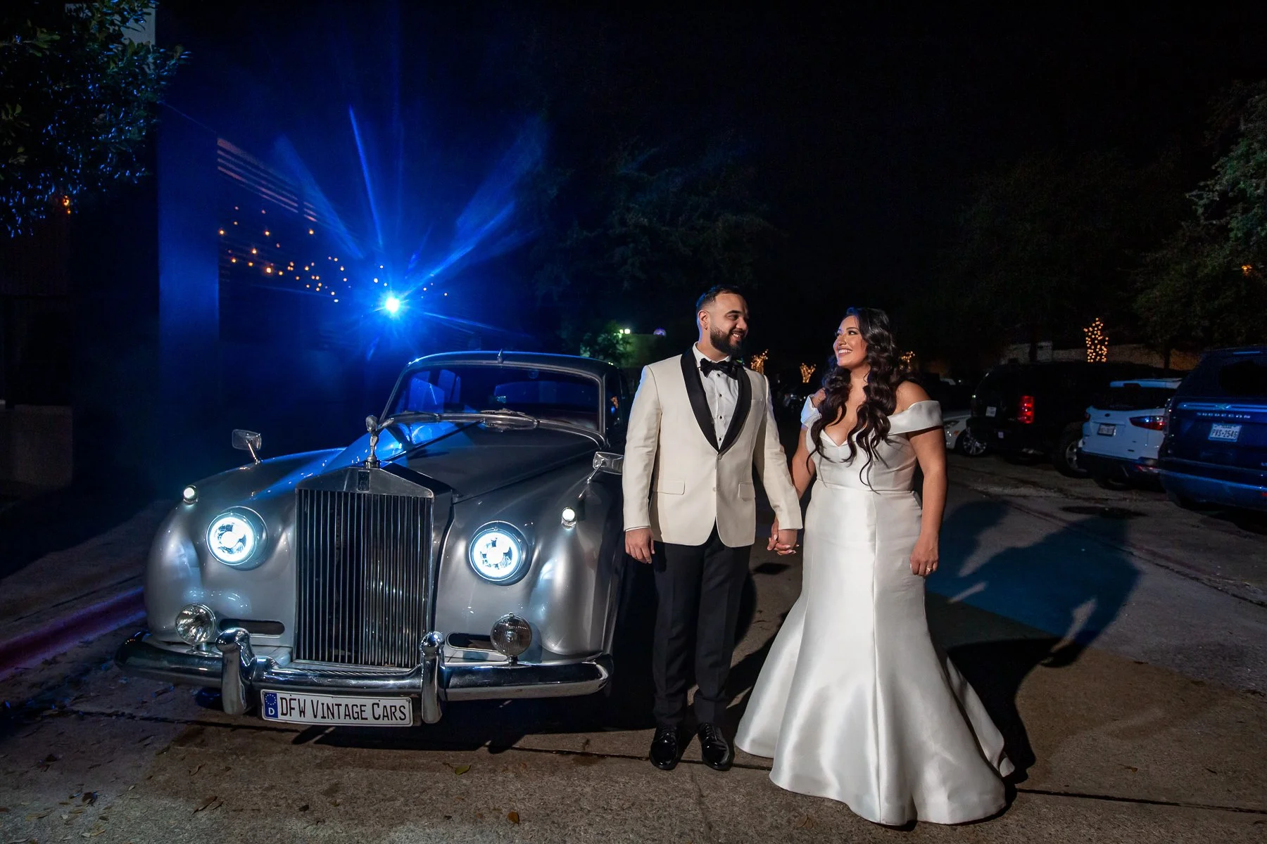 Bride and groom posing with a vintage car during their Hall on Dragon wedding in Dallas