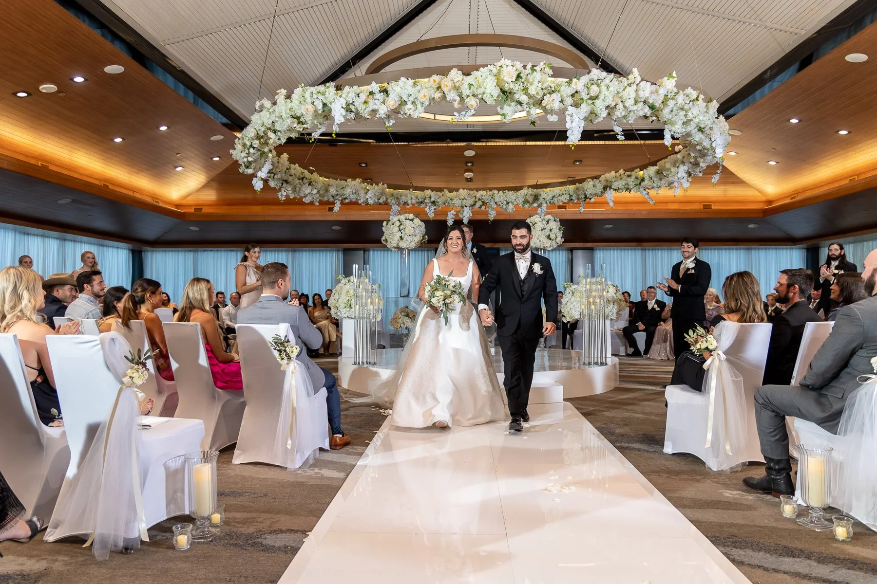 Bride and groom walking down the aisle after their wedding ceremony at The Westin Dallas Downtown