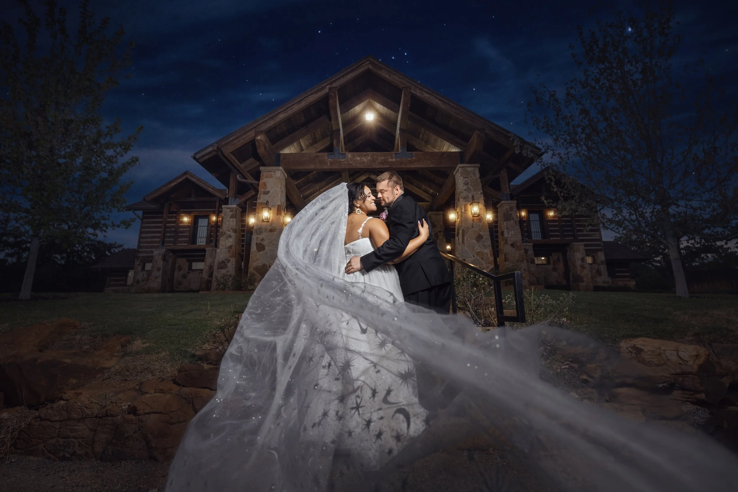 Bride and groom photographed outdoors after dark with creative lighting at a Dallas–Fort Worth wedding venue
