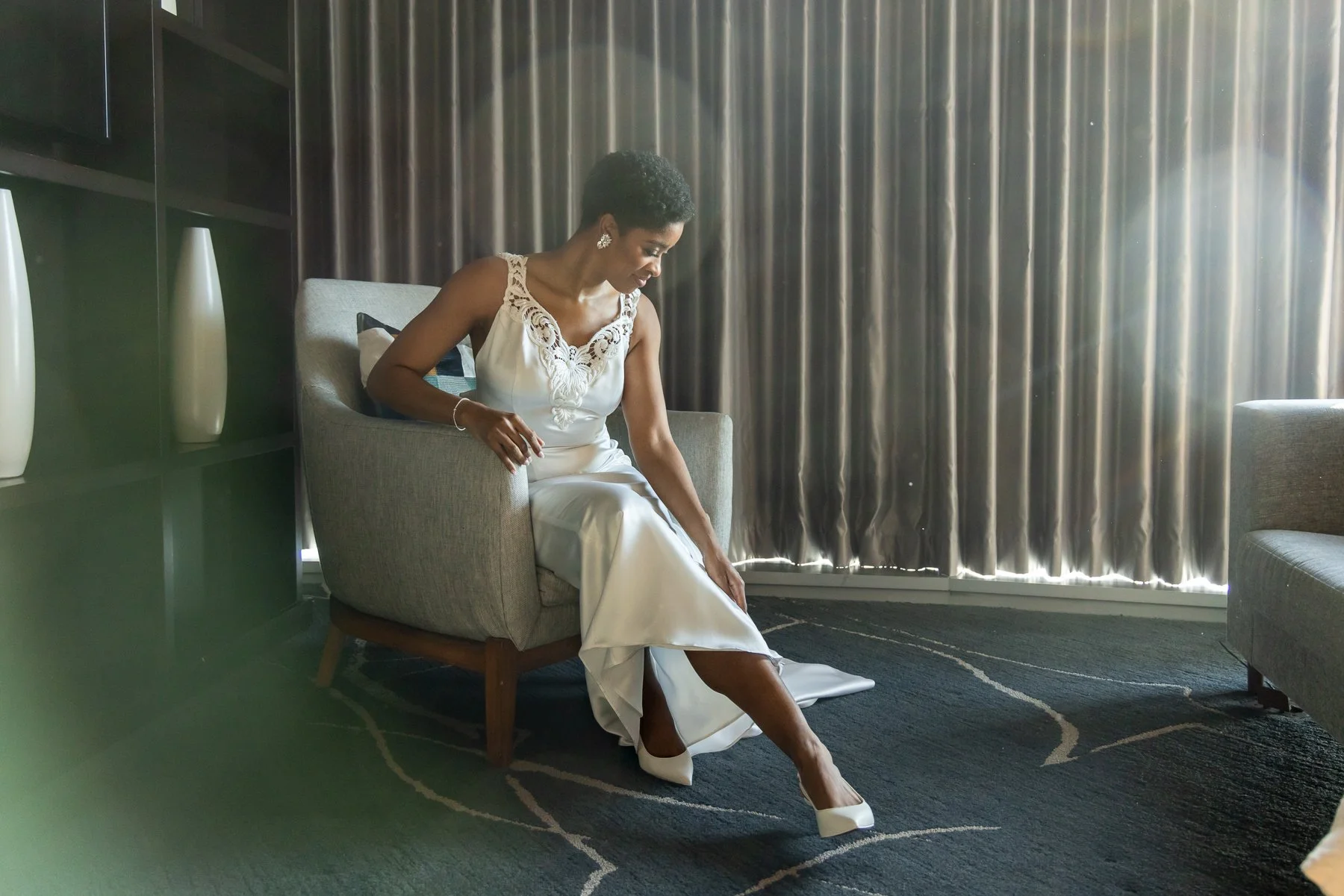 Bride getting ready by the window during her wedding at Omni Dallas Hotel in downtown Dallas
