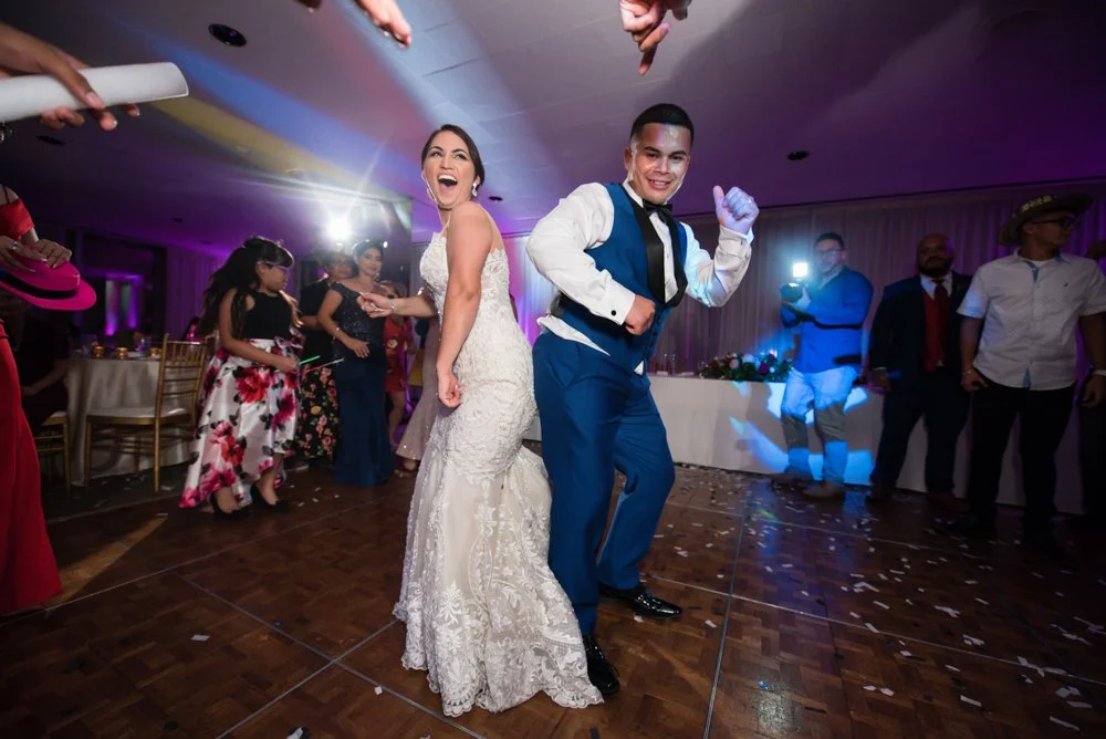 Bride and groom dancing with wedding guests during their reception at Tower Club Dallas in Dallas, Texas.