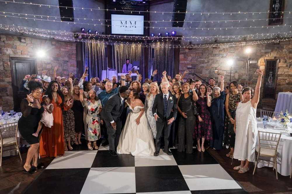 Wedding guests raising their hands on the dance floor at The Sanctuary.