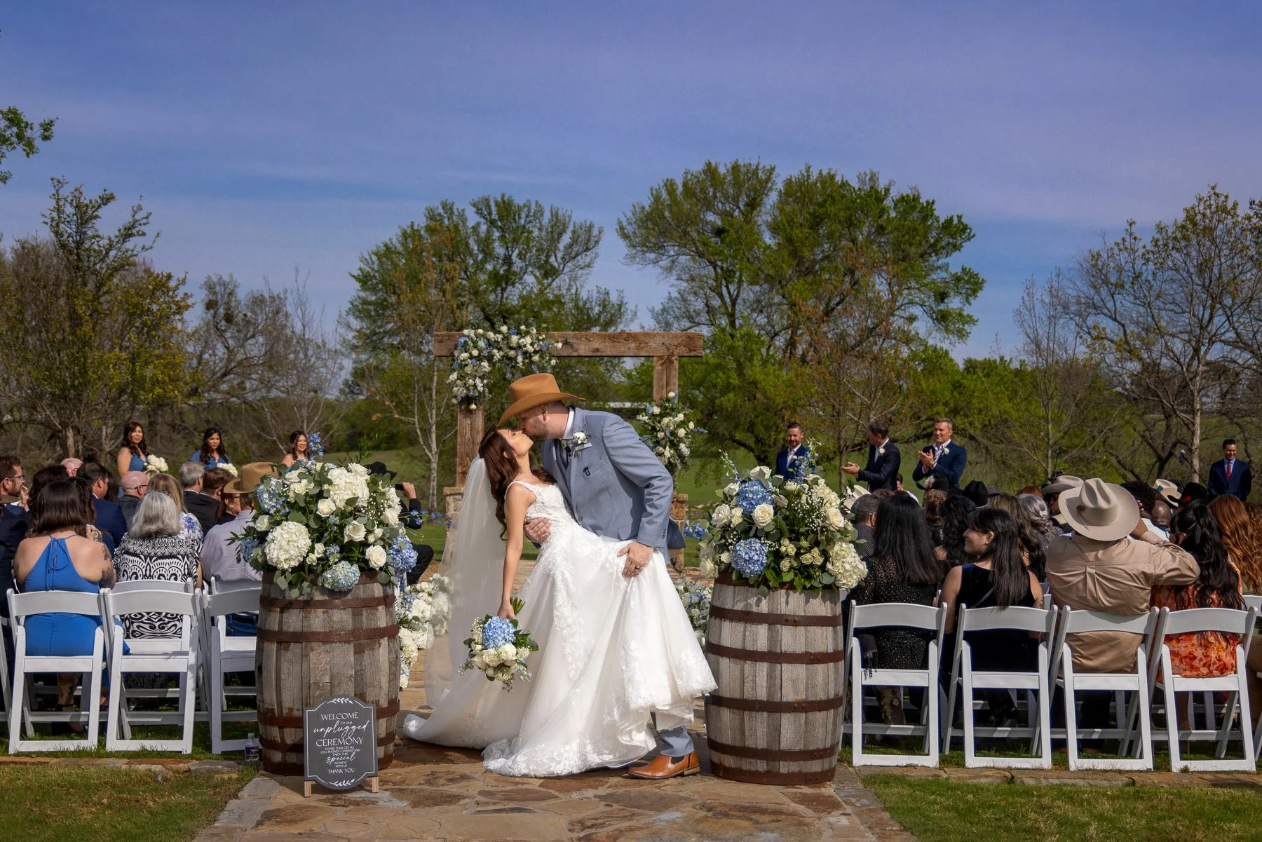 Bride and groom during their outdoor wedding ceremony at Lucky Spur Ranch in Justin, TX.