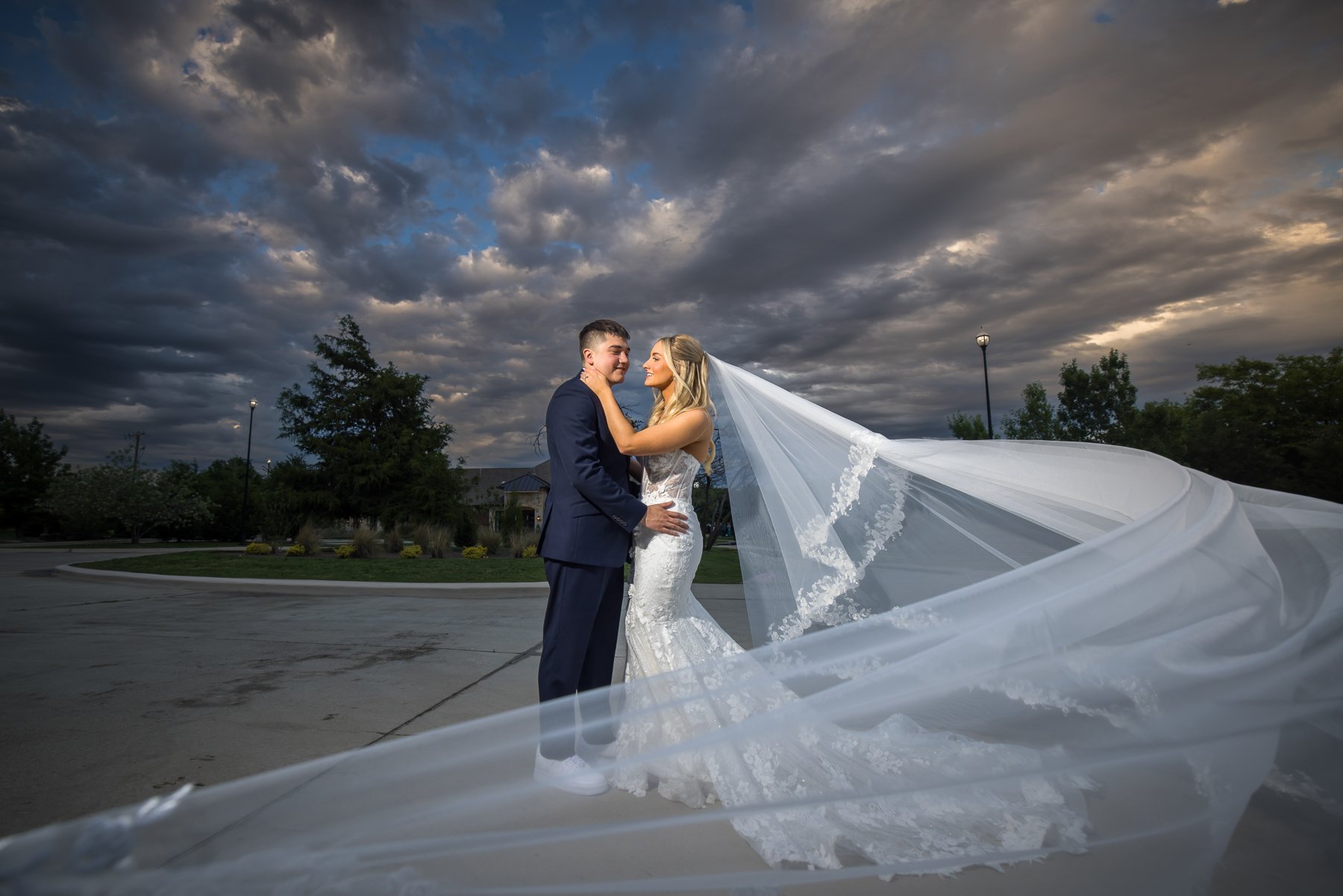 Bride and groom wedding portrait beneath dramatic skies at The Laurel.