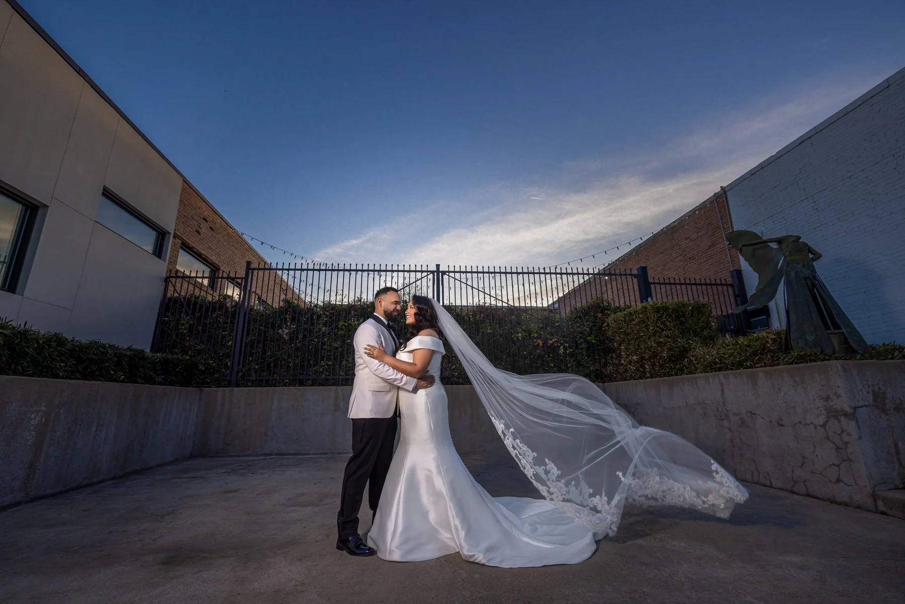 Bride and groom photographed with the Dallas skyline during their Hall on Dragon wedding