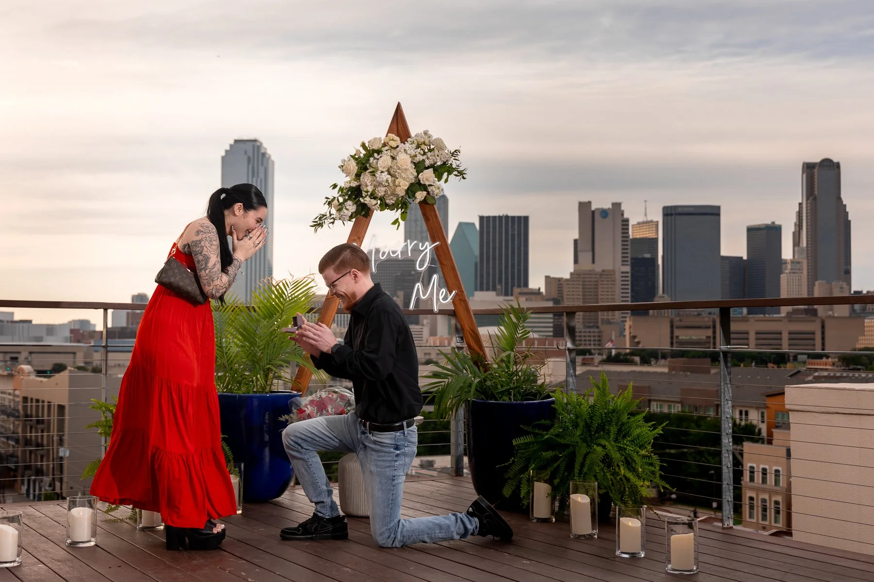 Surprise proposal overlooking the Dallas skyline with the groom on one knee