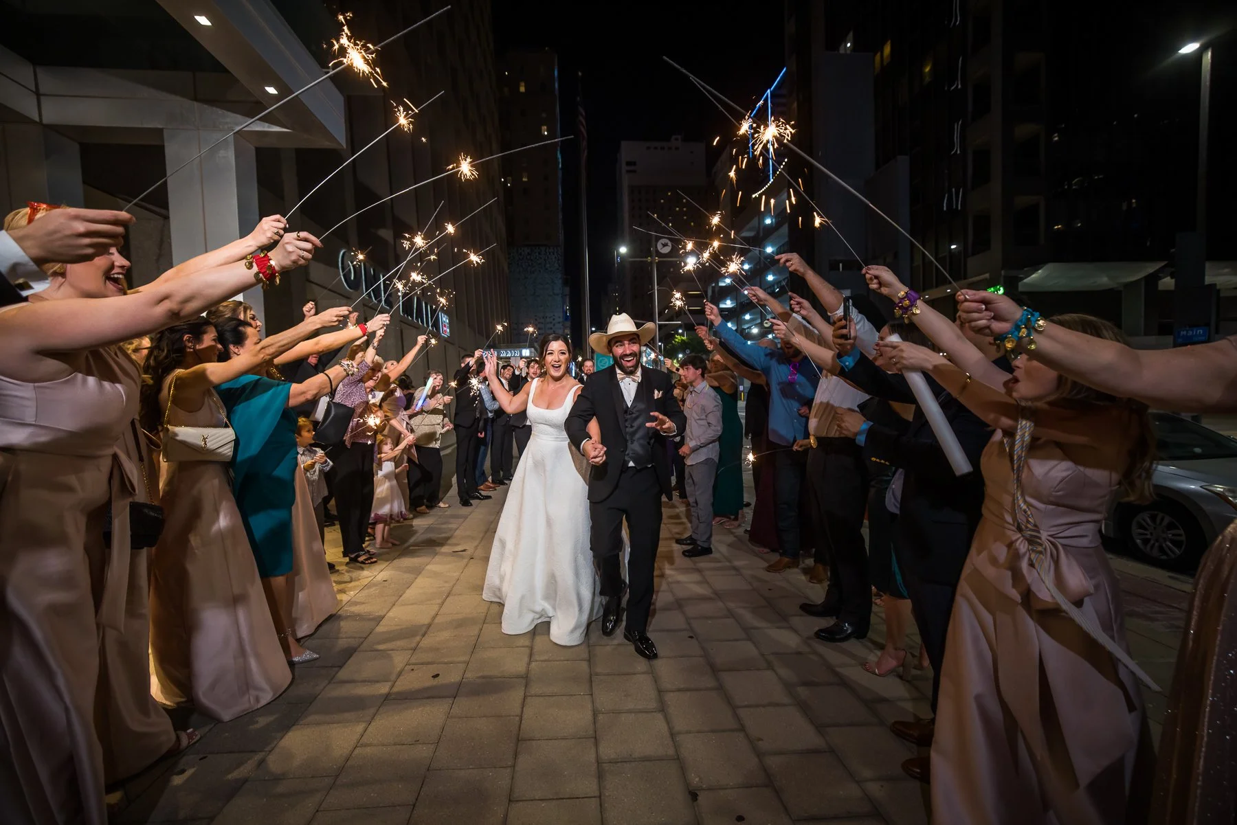 Bride and groom celebrating their wedding exit with guests at The Westin Dallas Downtown