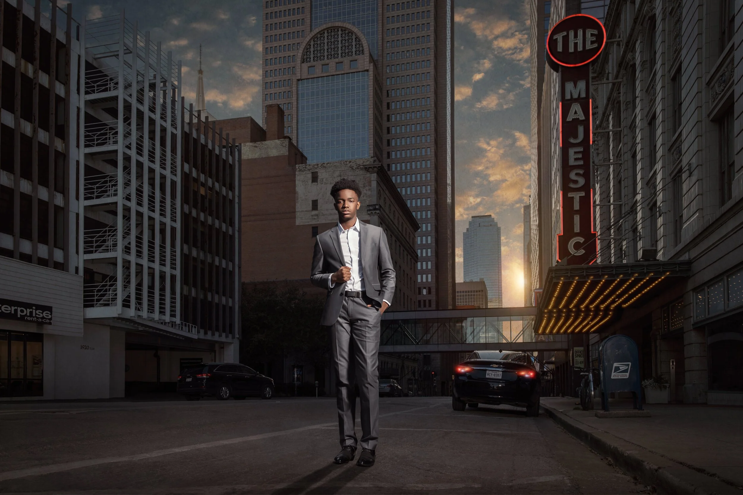 Male high school senior wearing a gray suit during an urban senior portrait session in downtown Dallas.