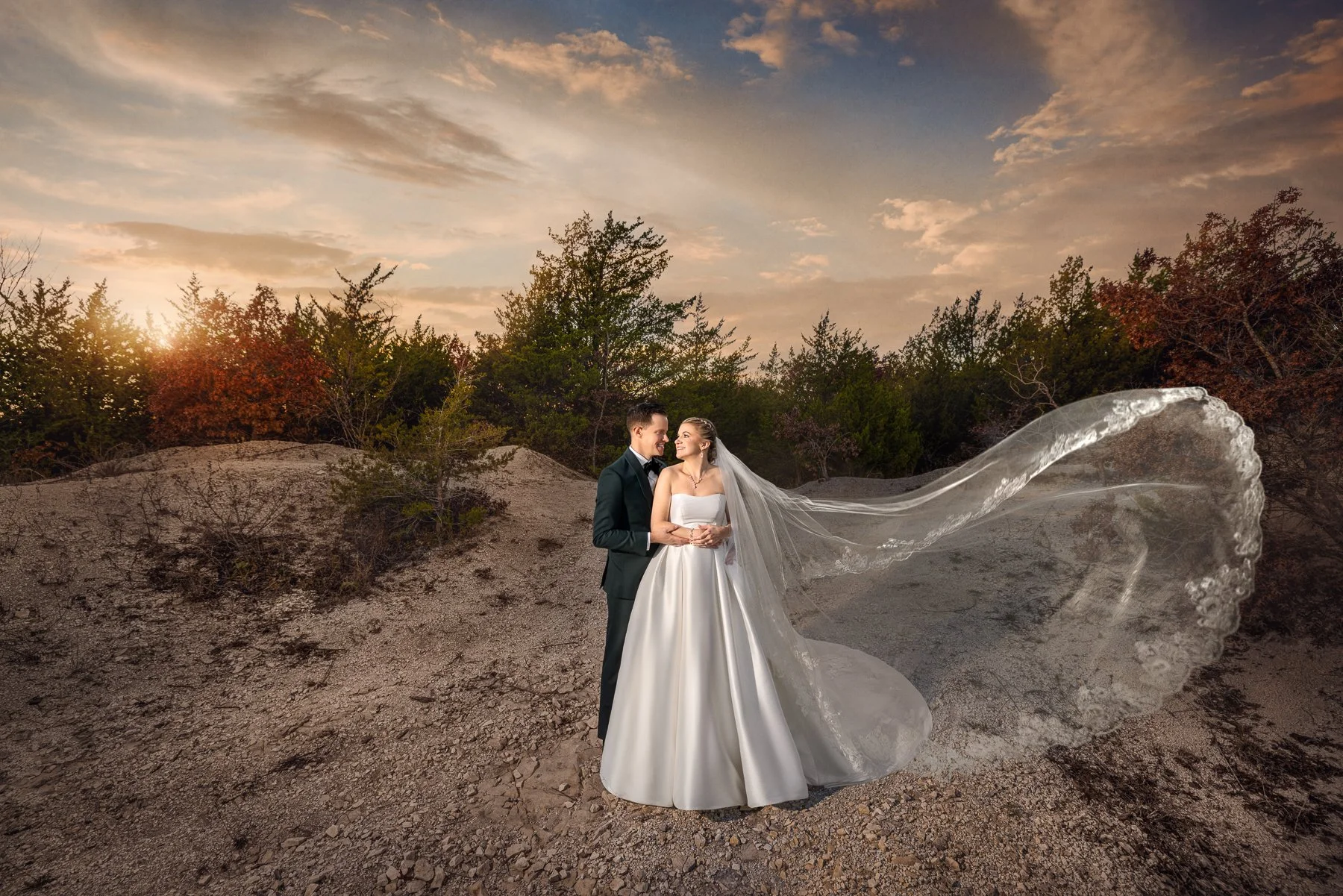 Bride and groom at sunset with flowing veil at Stone Crest Venue in McKinney, Texas