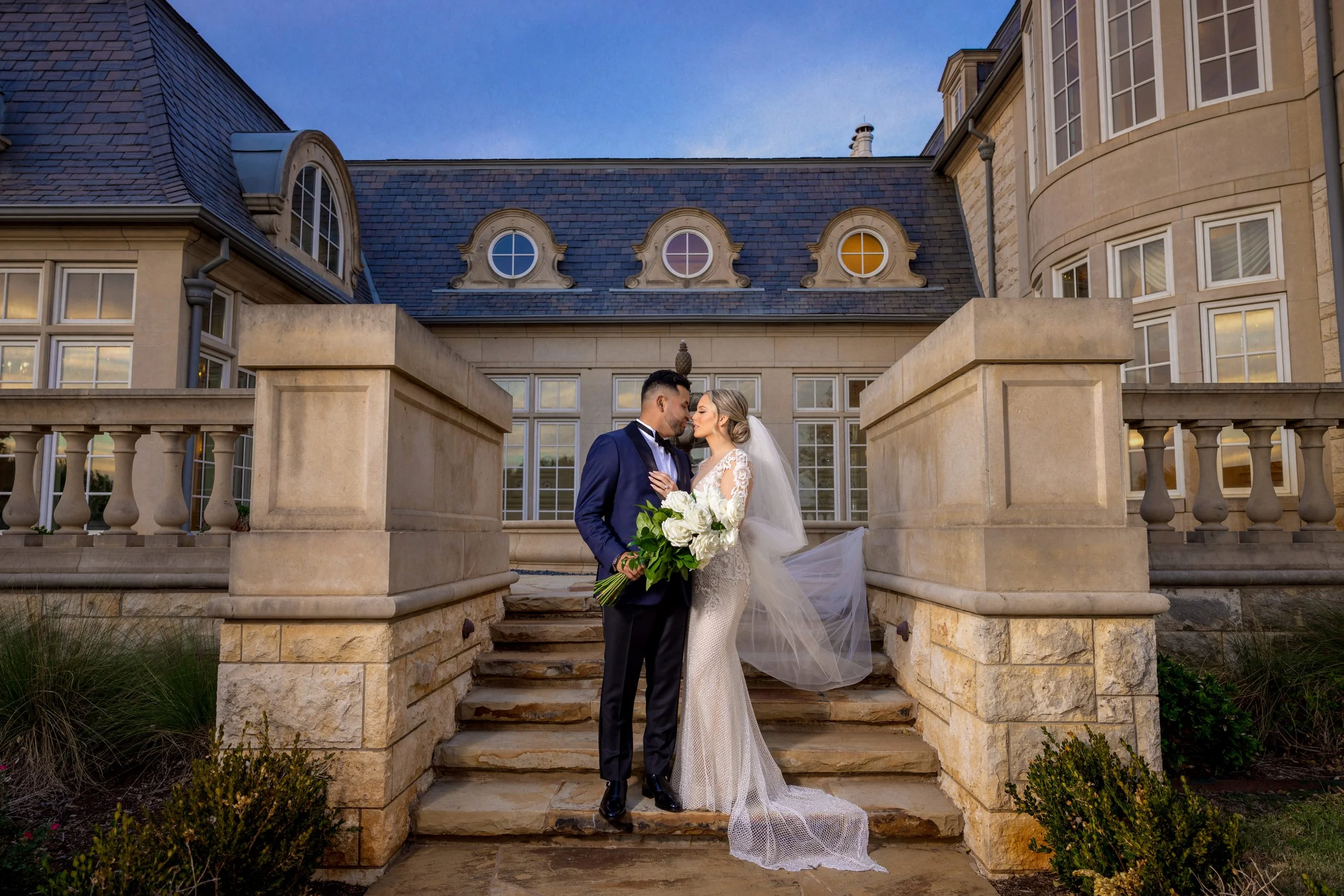 Bride and groom outside The Olana wedding venue in Hickory Creek, Texas