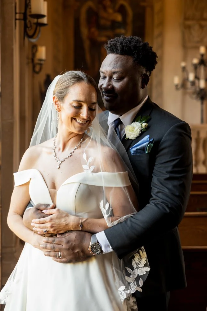 Mallory and Marcus smiling together in a close wedding portrait.