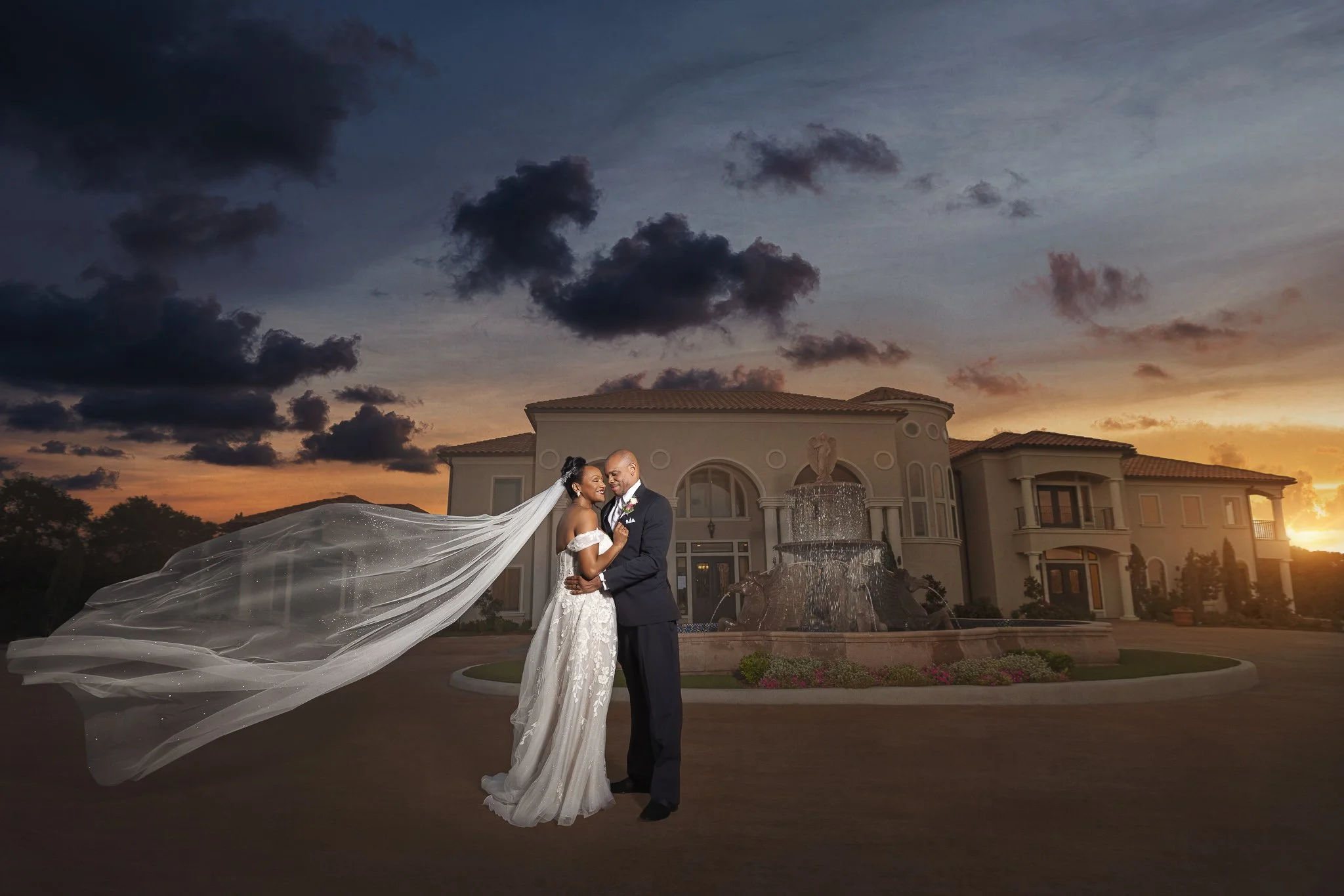 Bride and groom embracing in front of an elegant wedding venue at sunset in Dallas, Texas.