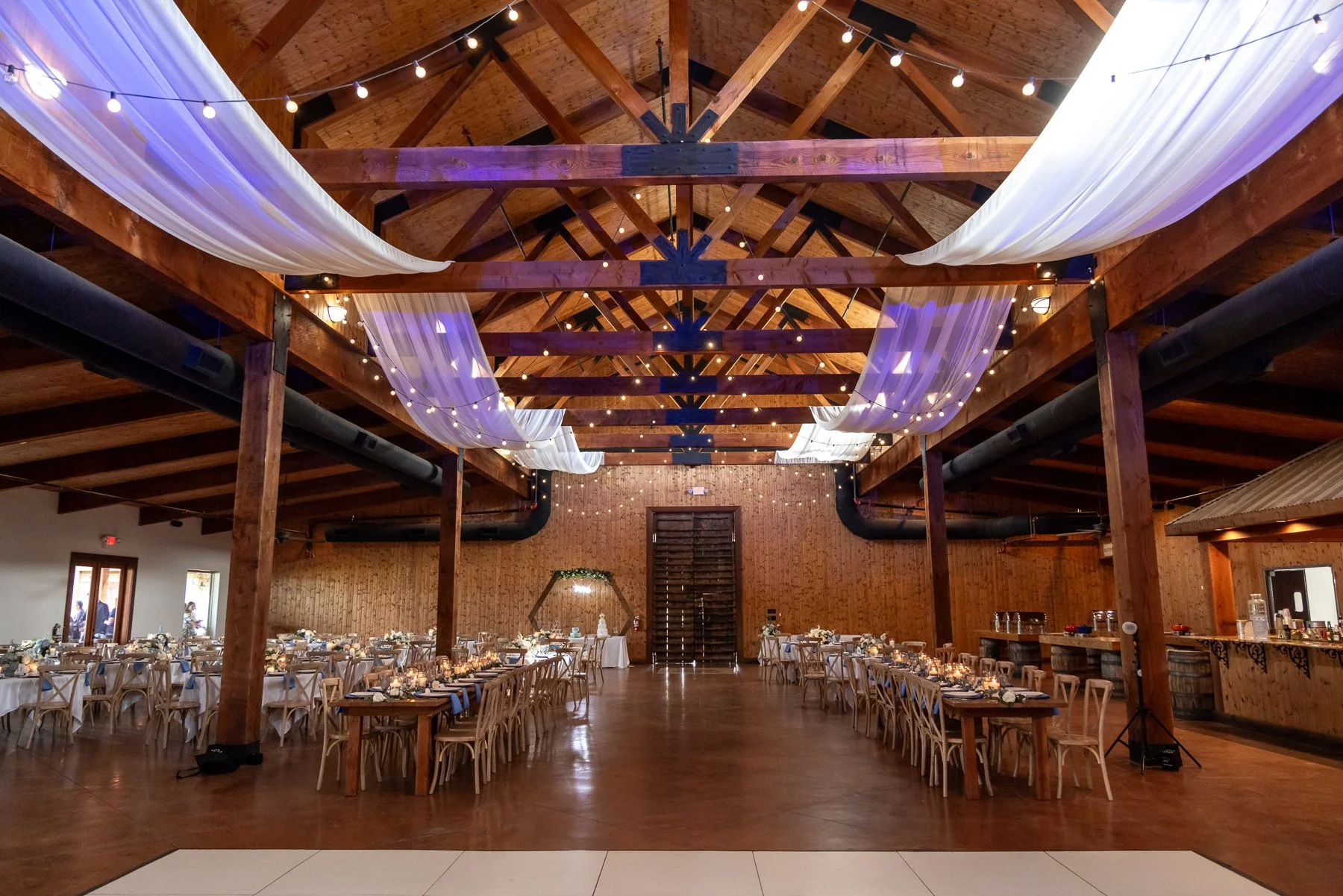 Wedding reception setup inside the barn at Lucky Spur Ranch in Justin, TX.