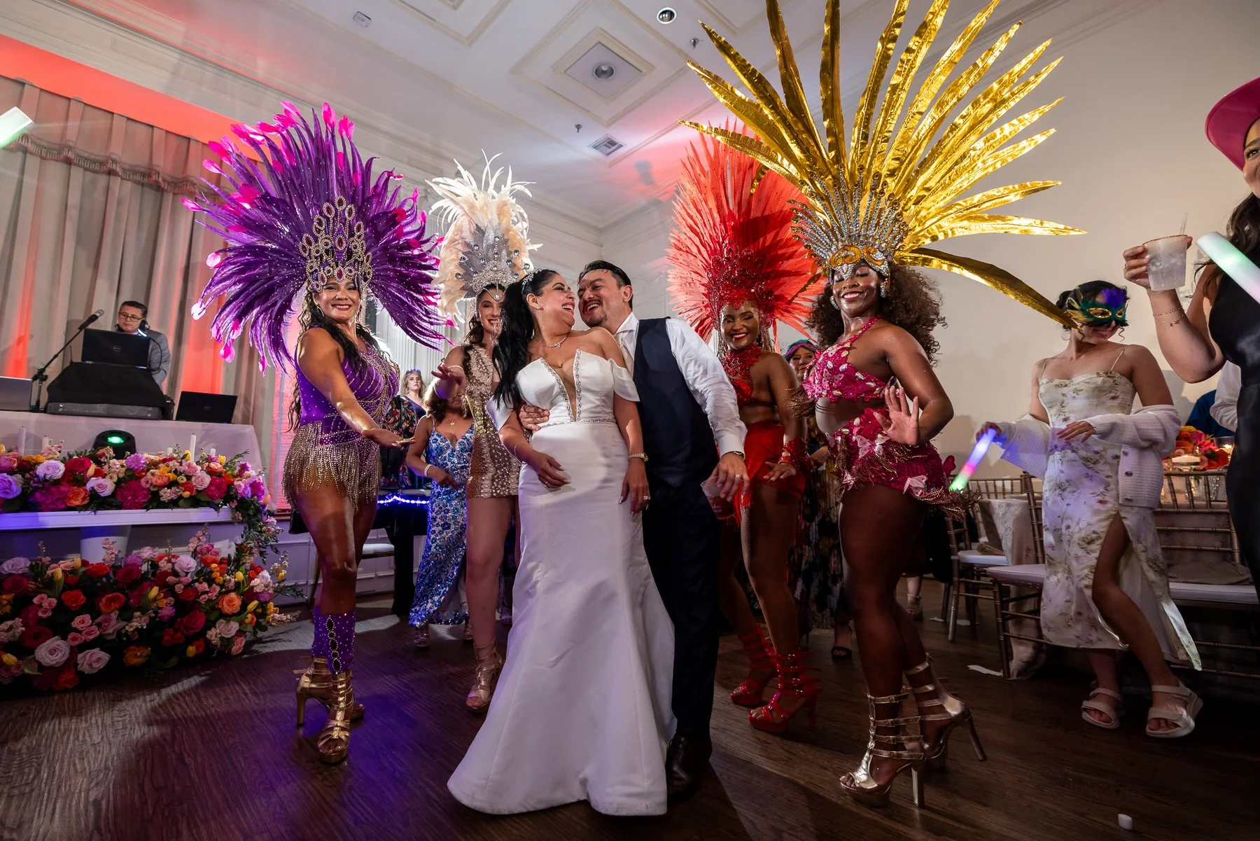 Bride and groom celebrating with live entertainers during their Arlington Hall wedding reception in Dallas.