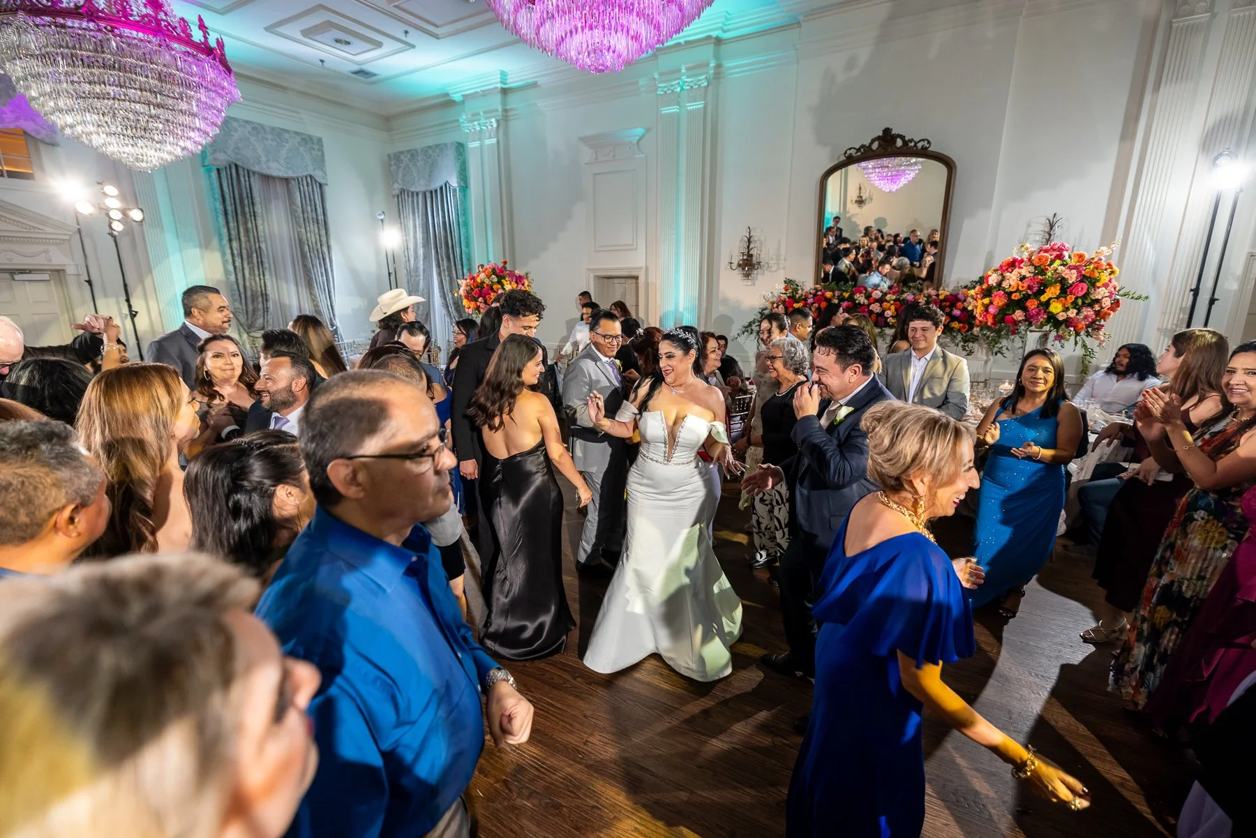Guests celebrating on the dance floor during an Arlington Hall wedding reception in Dallas.