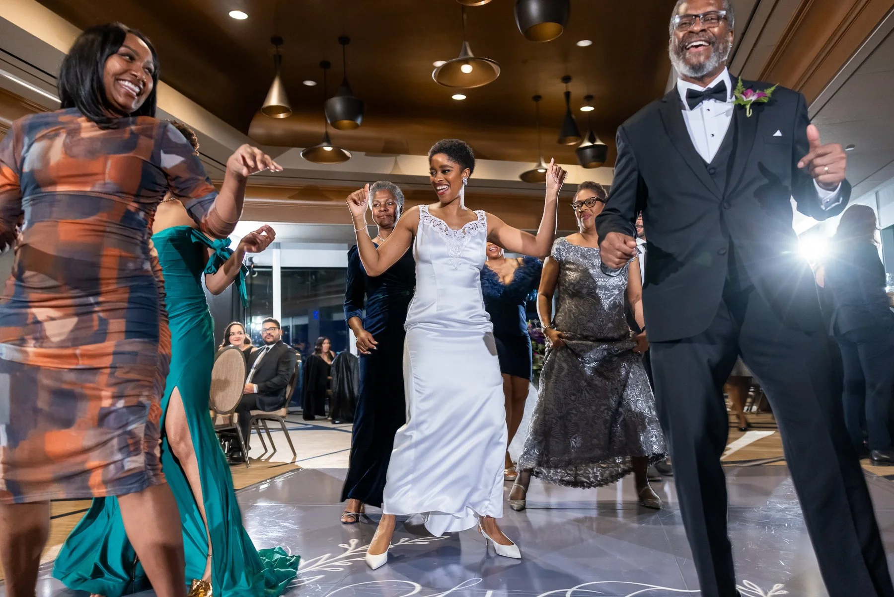 Bride groom and guests dancing during an Omni Dallas Hotel wedding reception