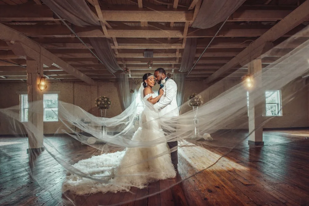 Bride and groom embrace inside BRIK Venue in Fort Worth, Texas, during their wedding portraits.