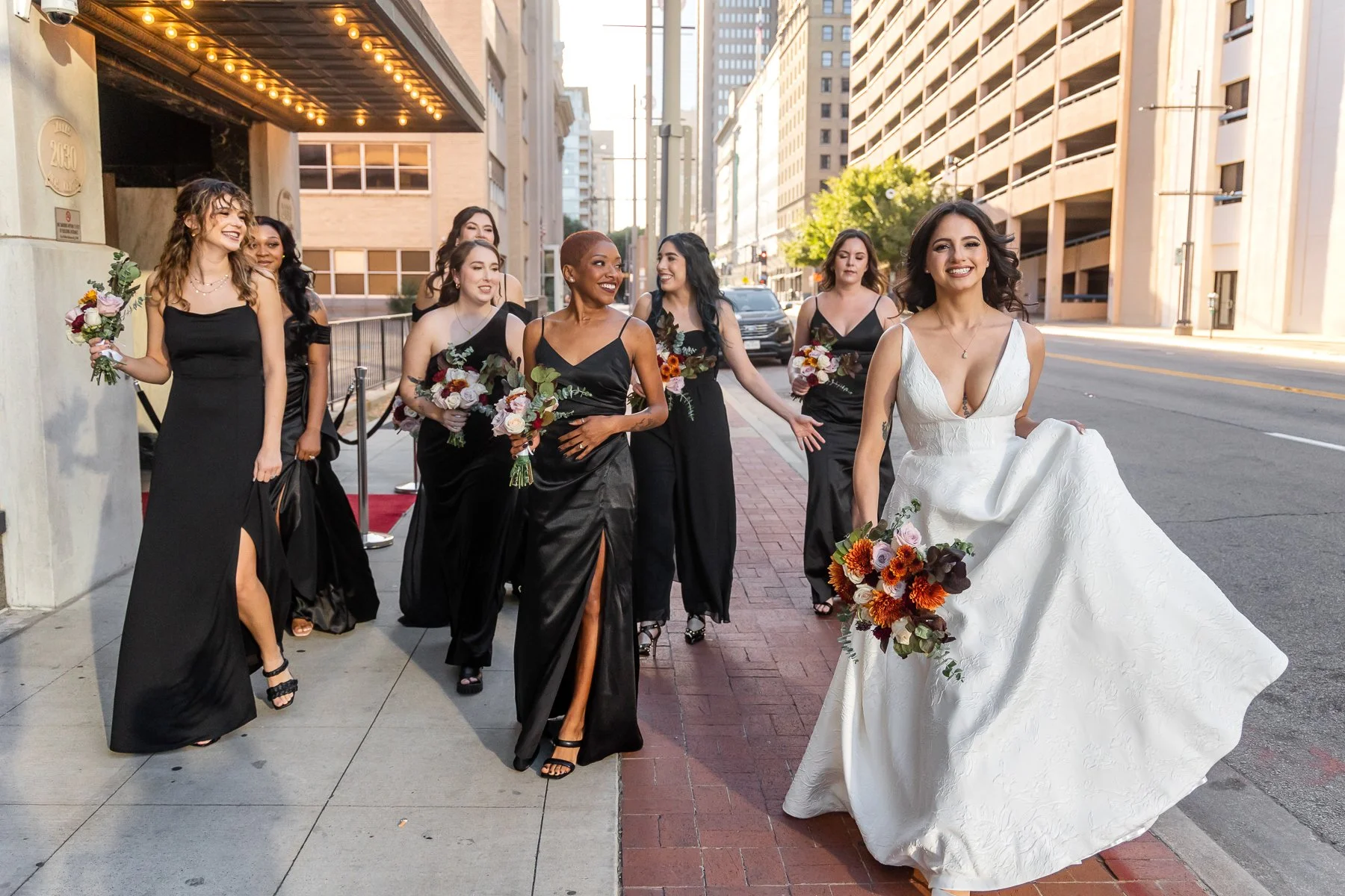 Bride and bridesmaids walking through downtown Dallas before a wedding at The Room on Main