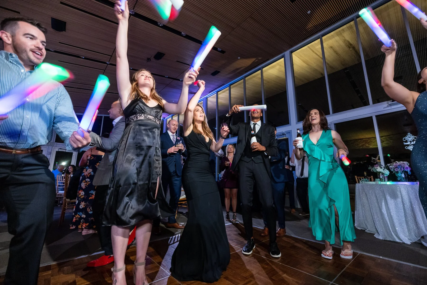 Bride and groom celebrating with guests during their Dallas Arboretum wedding reception in Dallas.