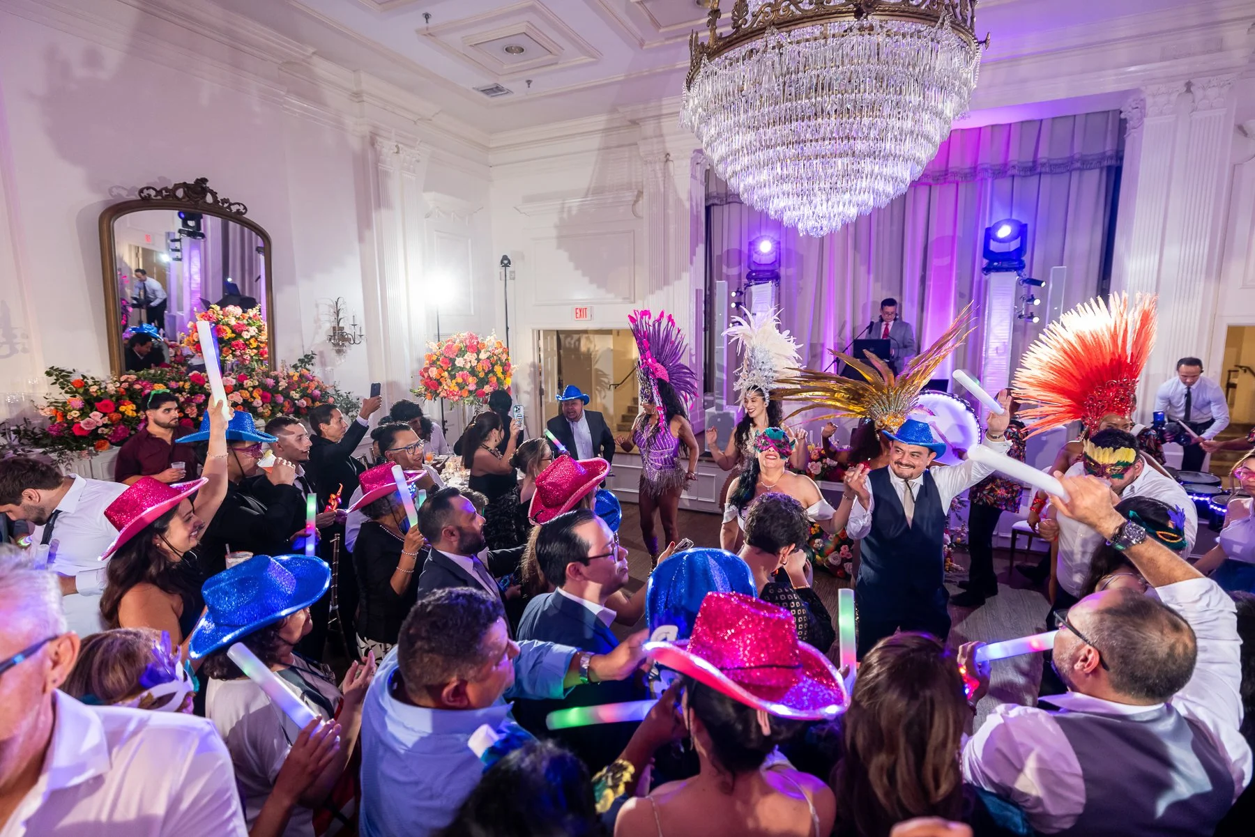 Packed dance floor and entertainment during an Arlington Hall wedding reception in Dallas.