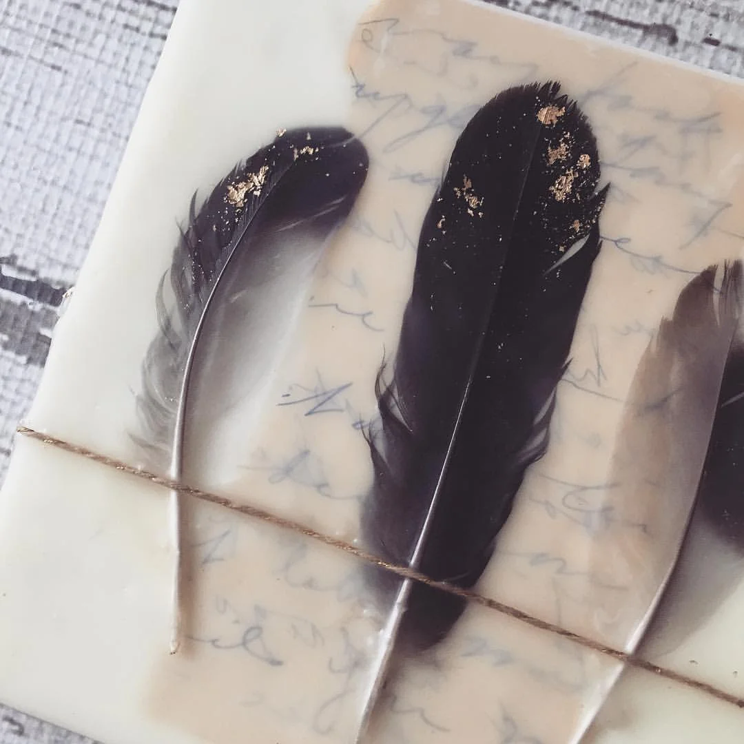 Embedded feathers and vintage papers in wax