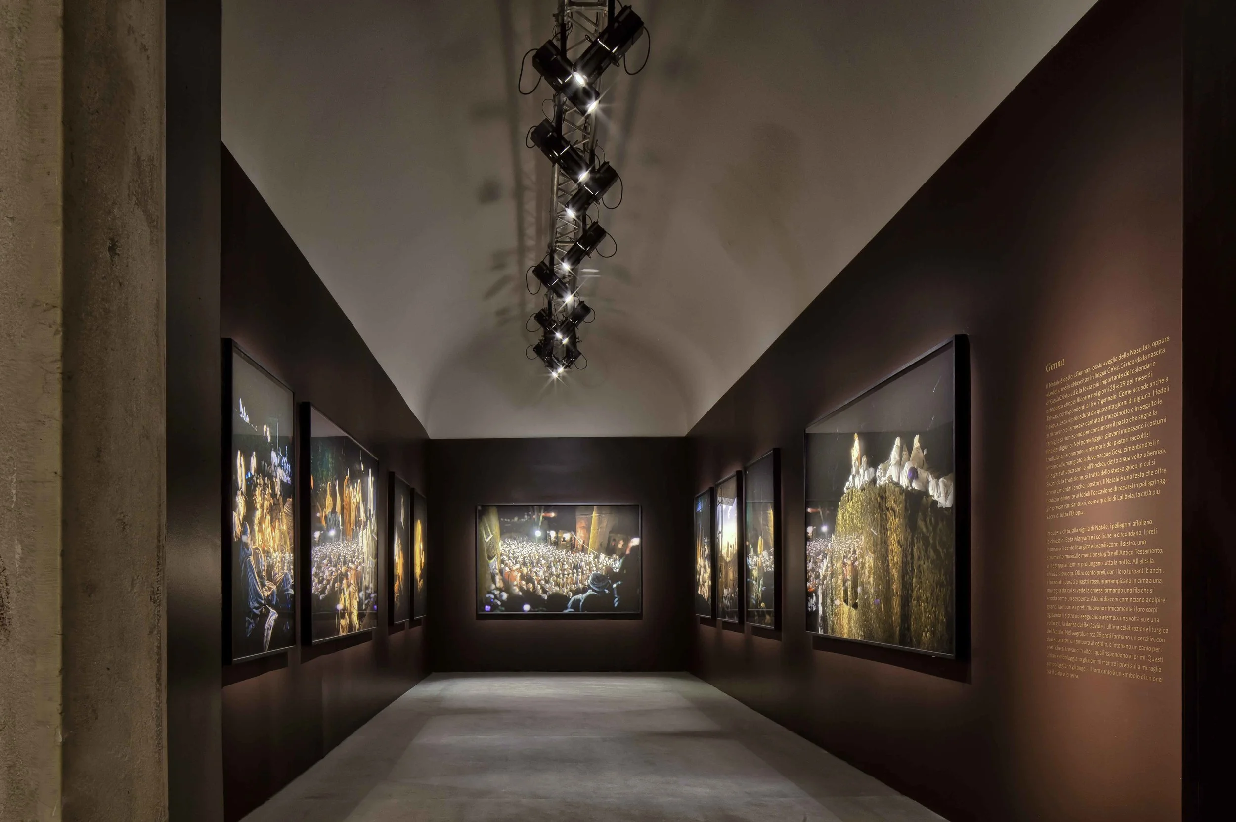 Photographic exhibition “Ethiopia Spiritual Imprints” Abbey of S. Giorgio Maggiore, Venice The set-up of Lizy Manola’s photo exhibition at the Officina del’Arte Spirituale on the San Giorgio Maggiore Island stems from two project objectives: to harmonize each photo with the surrounding space, carefully gauging the framing background; to create a suggestive atmosphere, able to evoke the deep spirituality of Ethiopian people. A number of ad hoc interventions have made space minimal, erasing reduntant details and rationalizing the way in between spaces. The result is a pure architecture, where photos of different intensity, light and colour have found their proper placement. A careful arrangement of light and shadow, veiled by the earthy tone of the background, intensify the profound fascination of the photographic narrative. Date: 2014 Architect: Paolo De Benedictis Assistants: Emina Gauzanovic, Maria Angilecchia Photography: Alessandra Chemollo << change project >> 