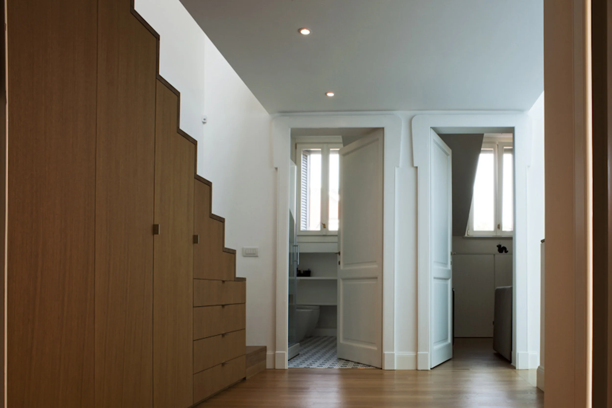 PR House, Milan The project involved the restoration of a small palace built in the early 1900s in the city centre of Milan. Although maintaining all the building’s original features, it made radical changes to the ground floor and the attic. The storage basement was raised so as to have the same height as the courtyard. This choice marks a series of spaces that from the main entrance cut through the stairwell and the living room, and succeed each other all the way to the courtyard at the rear of the building. The staircase, which used to lead from the road directly to the first floor, was replaced by a new flight connected to the other flights that lead to the upper floors. The storage spaces in the attic were reclaimed and included in the living quarters. In correspondence of these spaces, two wide copper skylights give character to the main façade. Although the project aimed at harmonizing the existing and new spaces, the inclusion of wooden straight-shaped elements underlines the discontinuity between the new rooms and those that have undergone conservation. Date: 2007 | 2011 Architect: Paolo De Benedictis Assistants: David Bigi, Eduardo Jose Giraldez Caro Structural Engineer: Marco Medizza Plumbing and Heating Engineer: Fabio Fumagalli Service Engineer: Paolo Passarella Photography: Alessandra Chemollo << change project >> 