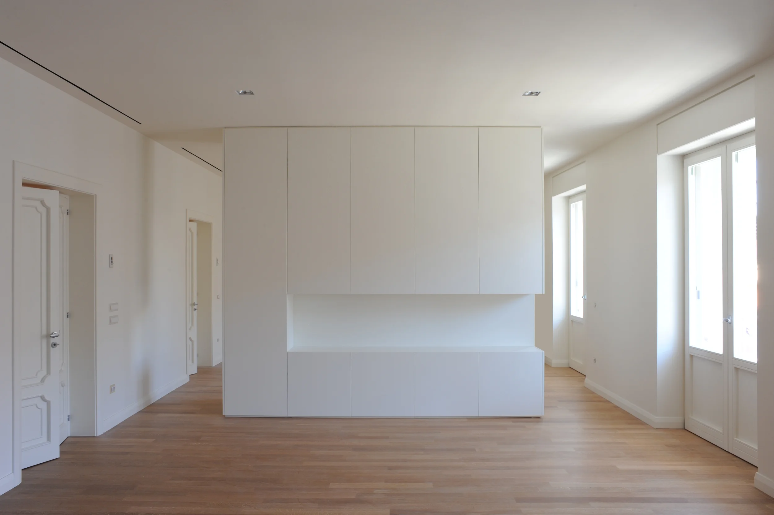 A House, Bari This 1950s apartment is located in the city centre of Bari, a few steps away from the sea. The project chose to maintain only the inner spatial distribution, characterized by a wide corridor in the middle, and to focus on the side rooms. The latter are thoroughly rethought in shape and size, so as to create broad, versatile and fluid spaces. The varying sequence of the doors facing each other on the corridor opens up new perspectives and emphasizes space transparencies diagonally. The radical use of white for the wall finishing and for the newly designed objects allows to integrate new interventions with the existing structure and to enhance the house peculiar character. Date: 2010 | 2011 Architect: Paolo De Benedictis Assistant: Eduardo Jose Giraldez Caro Service Engineer: Marco Evangelista Photography: Nicola Di Nanna << change project >> 