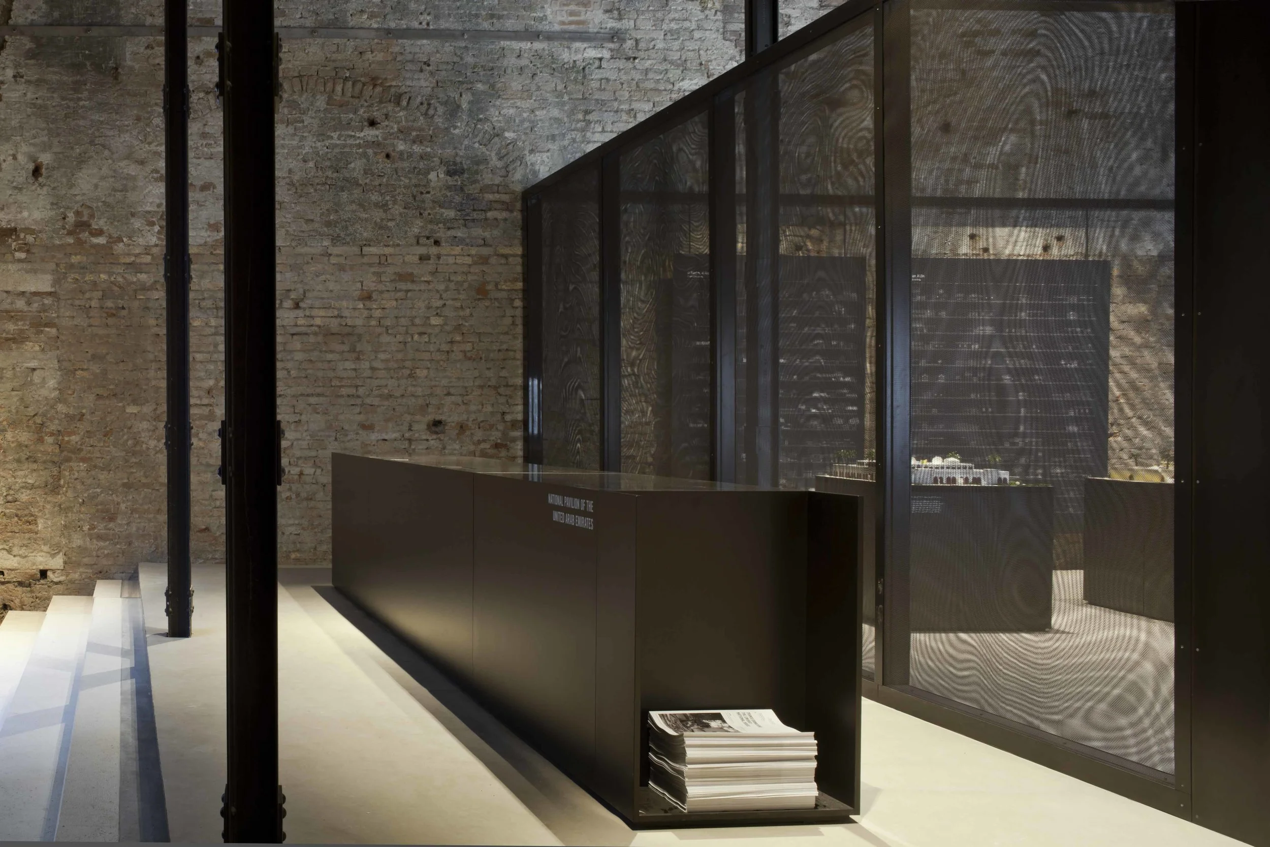 National Pavilion UAE, Arsenale, Venezia Architecture Biennale 2016 Competition first prize The building of the Sale d’Armi, the permanent pavilion of the United Arab Emirates, is a distinctive building from the 16th century that is characterized by an askew grid that follows both the longitudinal load bearing walls and the array of steel columns. The design succesfully creates a multi-layered dialogue between the project and the existing structure, from which it infers the geometric organization while maintaining a visual and physical space between the content and the container. A progression of solid and perforated metal partitions are artfully situated within the space of the pavilion so to create a course within the exhibition that is equally spatial and visual. Date: 2015 | 2016 Commissioner: Salama Bint Hamdam Al Nahayan Foundation Curator: Yasser Elsheshtawy Coordinating director: Laila Binbrek Exhibitions coordinator: Rand Abdul Jabbar Architect: Paolo De Benedictis Assistants: Emina Gauzanovic, Maria Angilecchia Structural Engineer: Luca Pulignano Photography: Alessandra Chemollo << change project >>