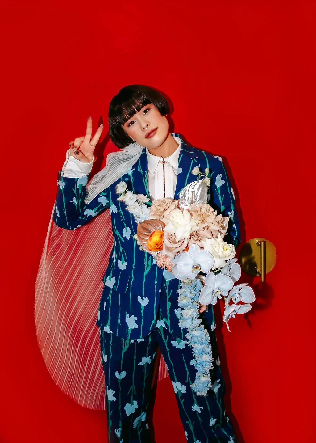 bride with bold suit and flowers