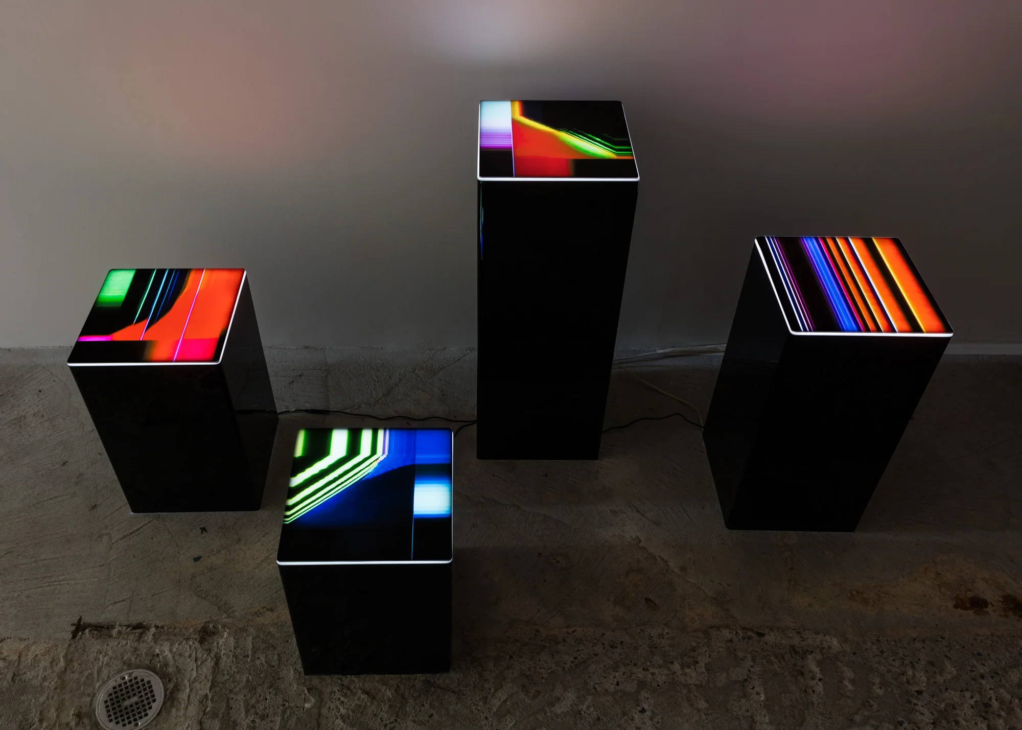 Rose Kallal Tesseract , 2019 Four plexiglass pedestals with lighted Duratran prints Dimensions variable