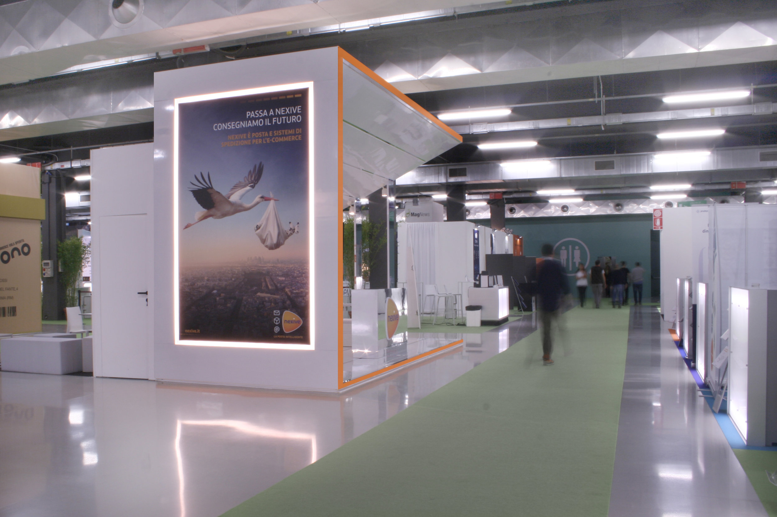 La parete dello stand con la grande immagine pubblicitaria incorniciata da luci led.