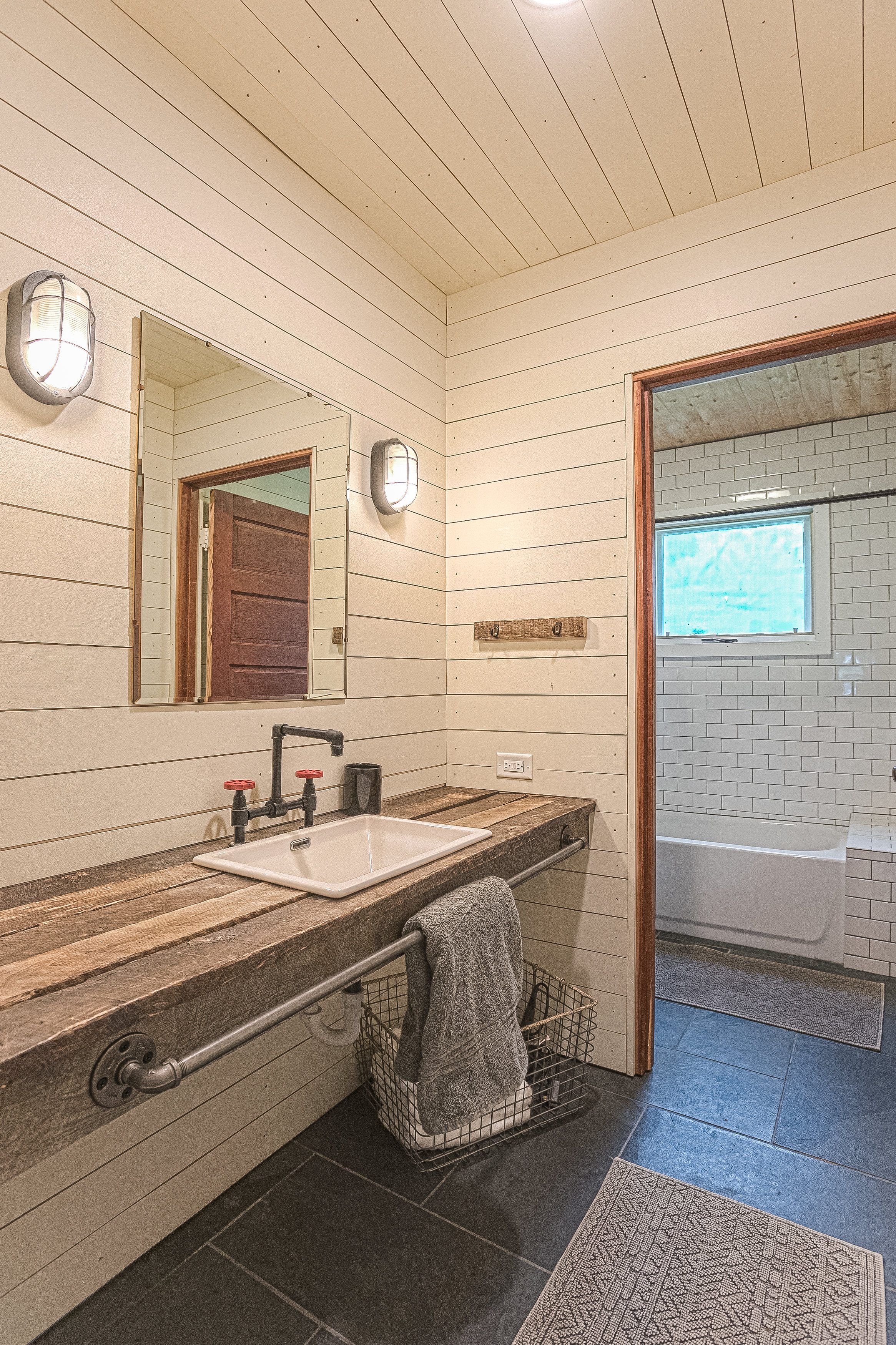 Main house guest bathroom with lots of character including steam punk faucet, reclaimed timber vanity and subway tile. Brushing your teeth has never been so much fun!