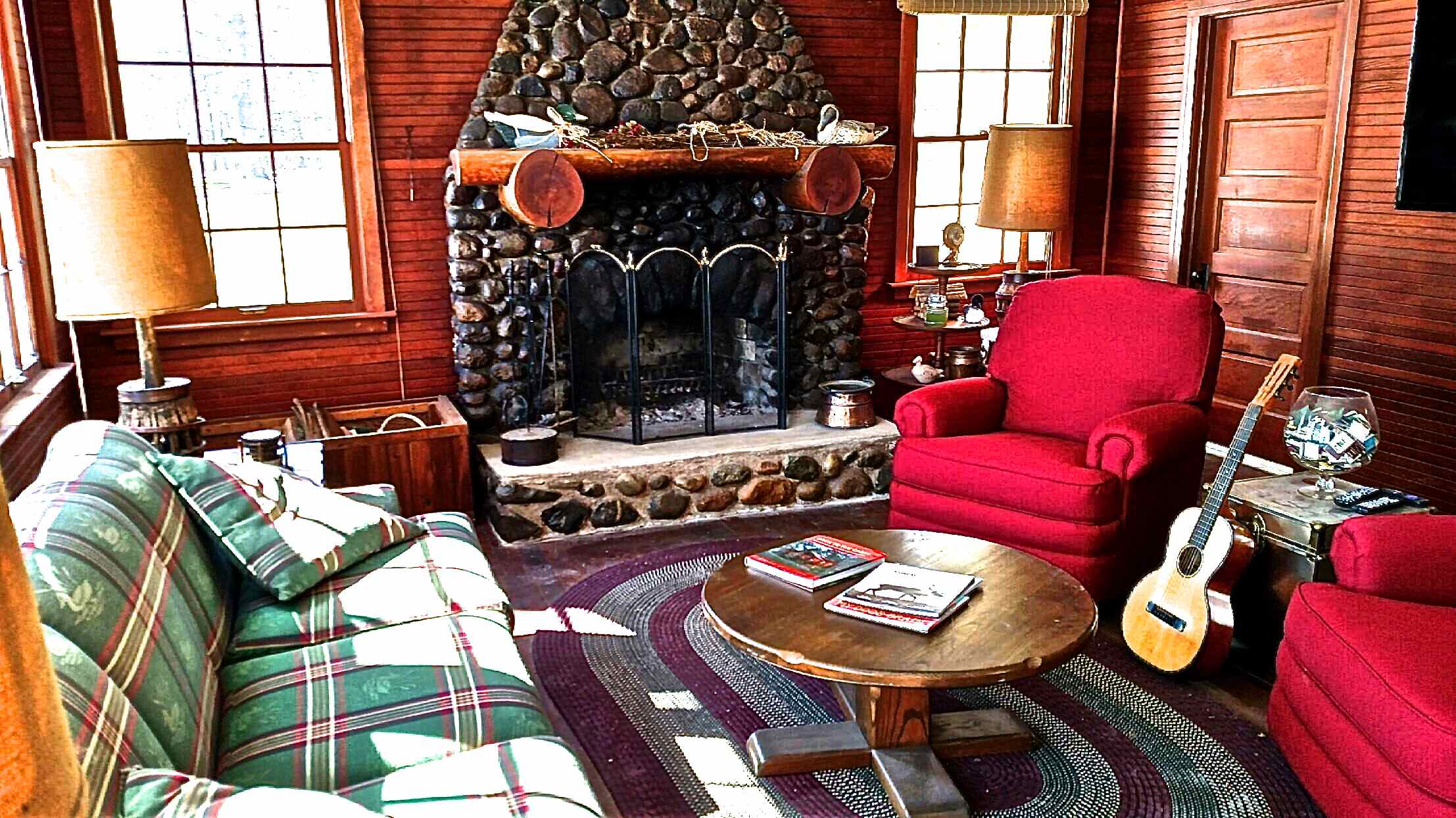 No imitations...this is a vintage MN lake experience inside and out featuring a main house living room with fir paneled wall, historic fireplace built with stones from Sugar Lake and comfy red swivel/rocking chairs for storytelling or spin around and stream your favorite movie on the flat screen TV.