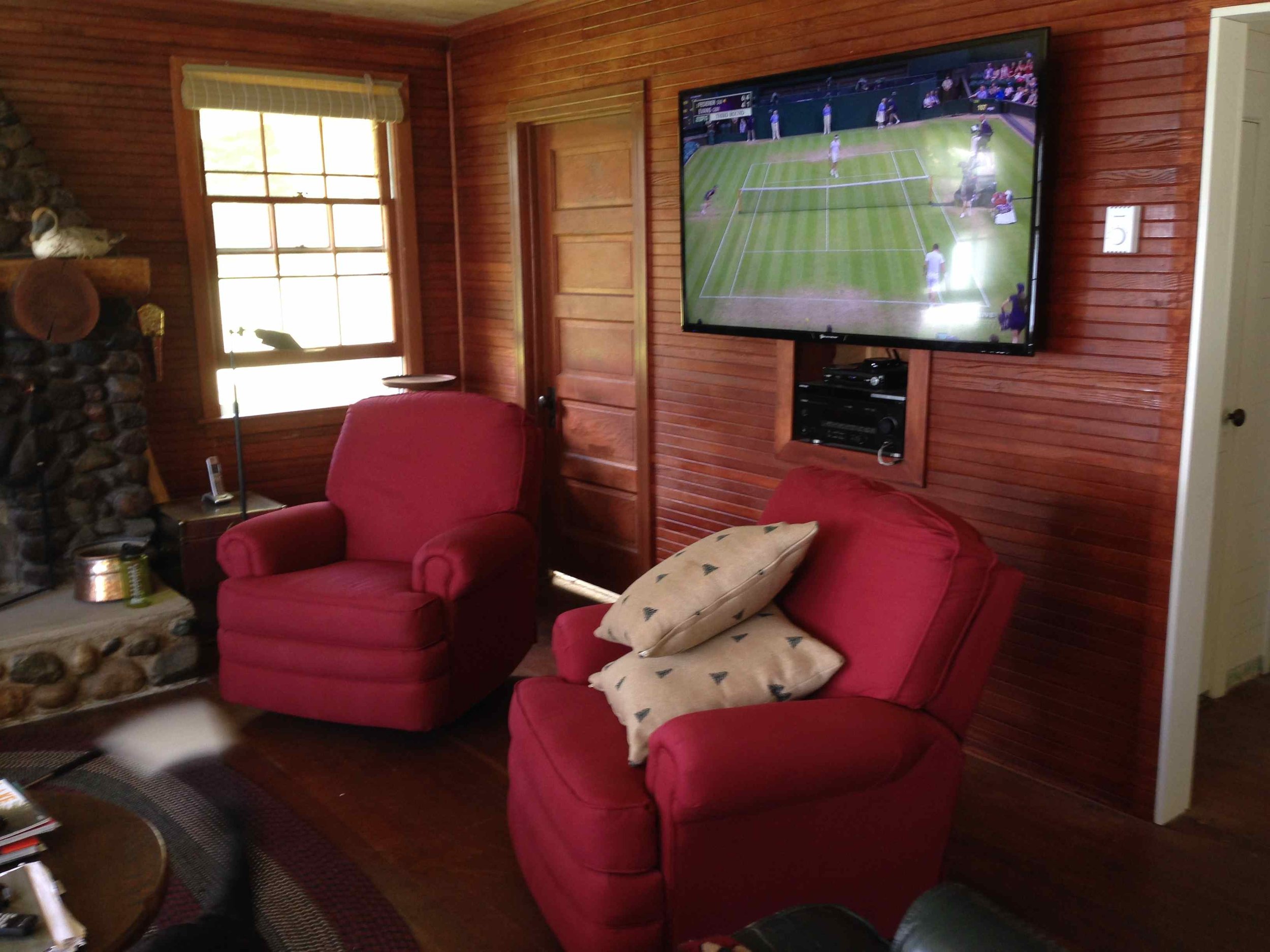 Red rockers swivel and two generous sized couches hold a big crew for movie night.