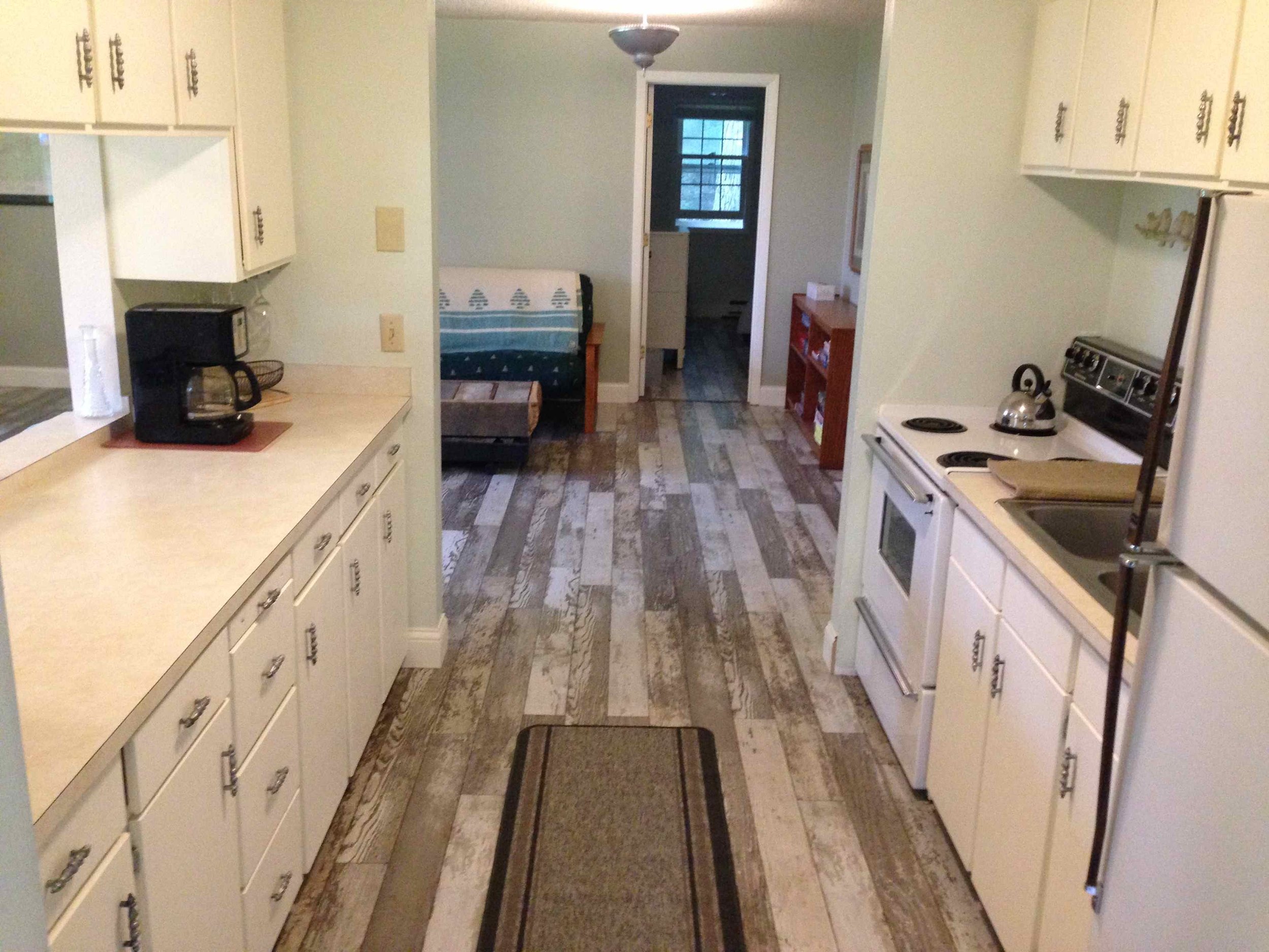 Little house kitchen with view into living room.