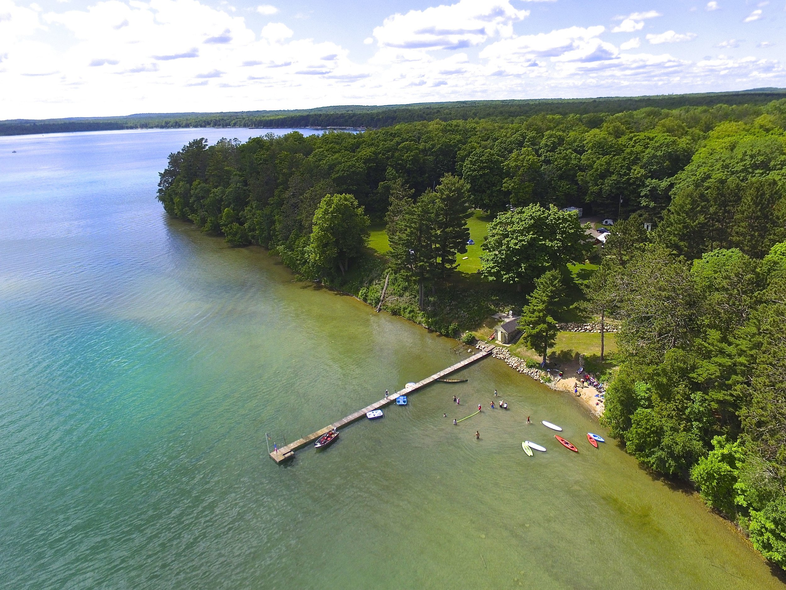 The sandy beach is a big hit with kids and adults alike and extends east of the dock and stone boathouse. Kick back in one of our Adirondacks or wade into the crystal clear water and grab a kayak or paddle board. Our plug-and-play mooring system (seen above) means no lugging your gear in and out of the water. Just un-clip and go and re-clip when you return.