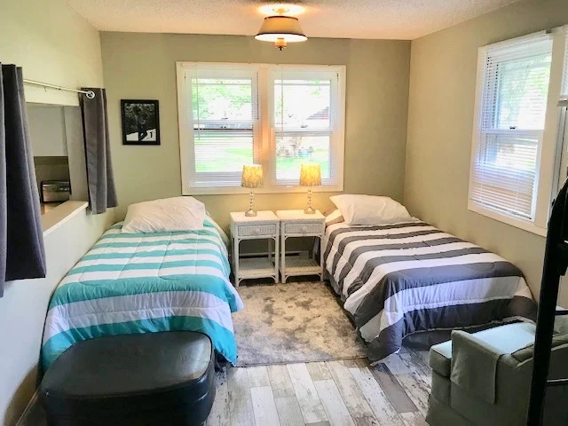 Little house group room features two twin beds pictured above, a bunk bed (two twin bunks) pictured to the right and a queen futon. This is a great room for the kids (late night ghost stories) or for an adult couple with an infant or younger children.