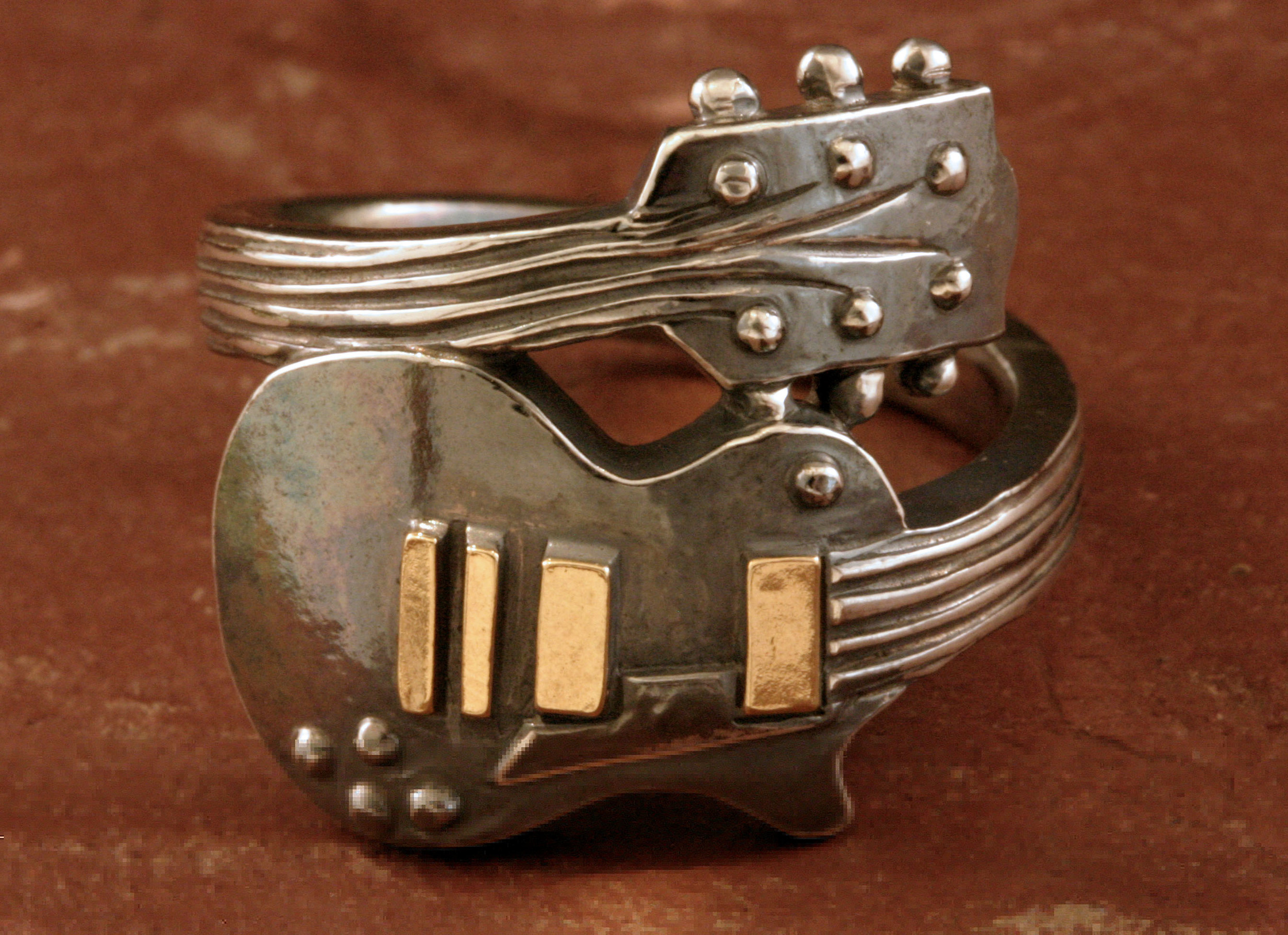 A guitar ring in oxidized sterling silver & 14K gold