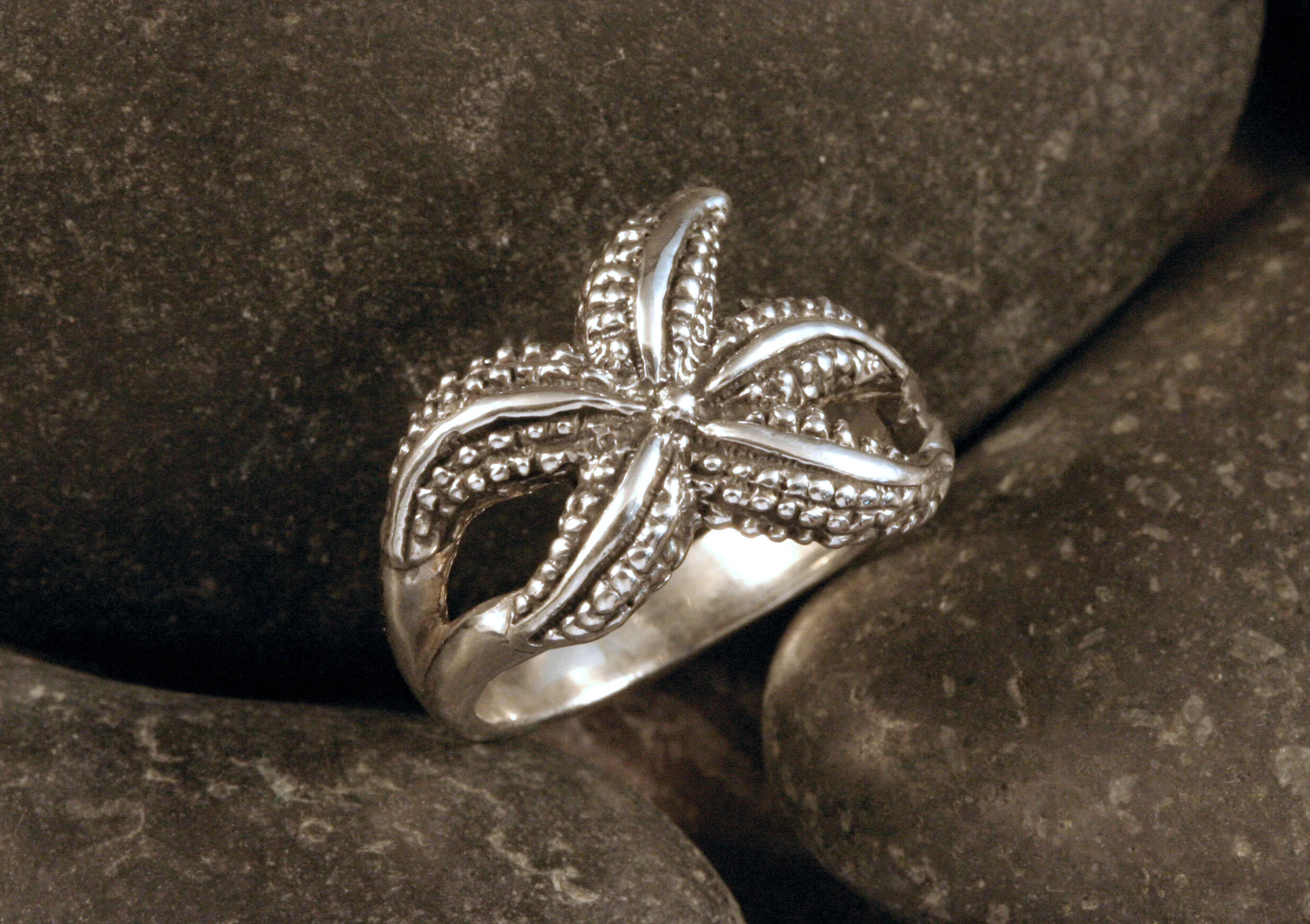 An oxidized sterling silver textured stylized dancing starfish ring.