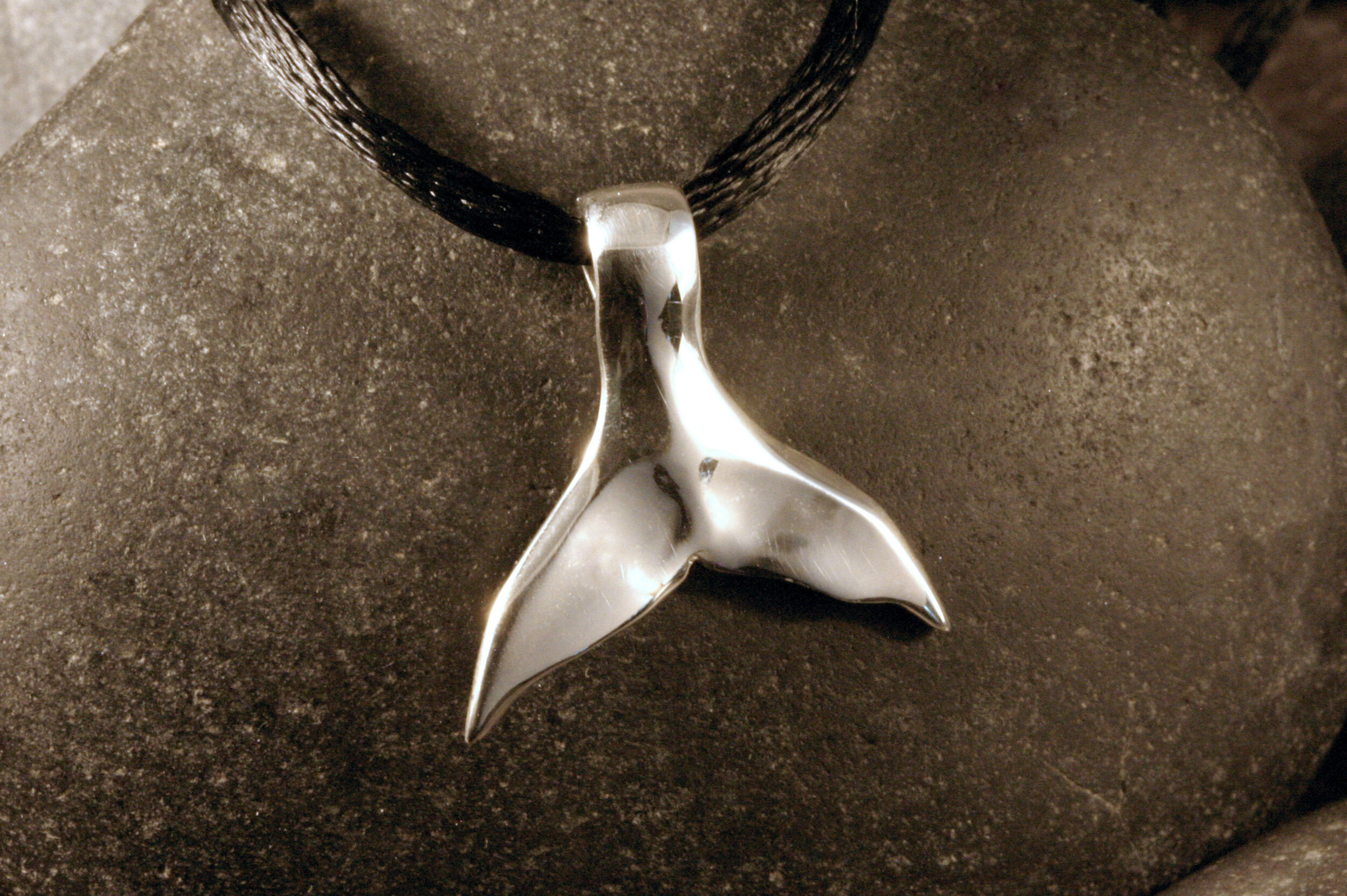 Medium sterling silver whale tail pendant.