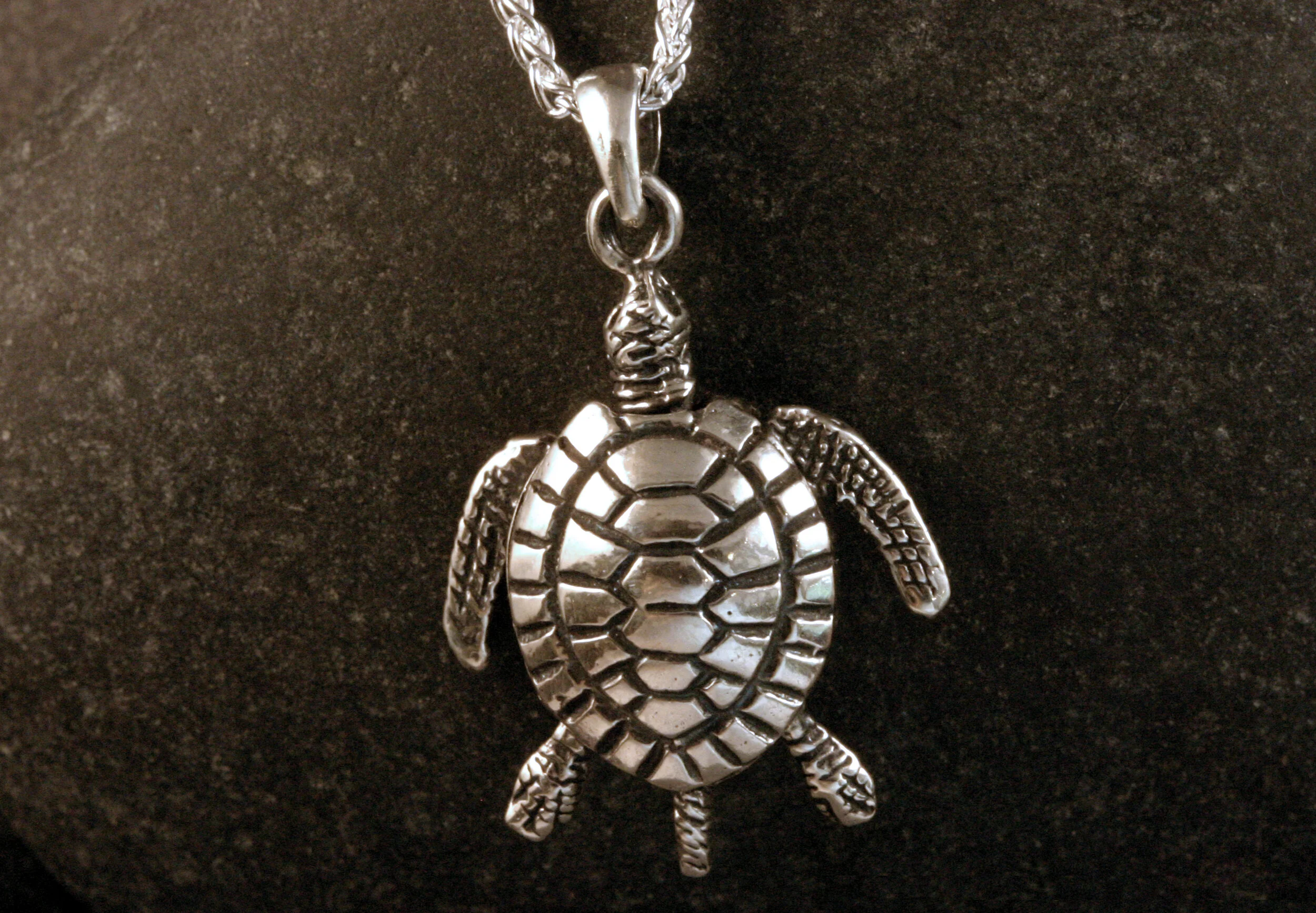 Oxidized sterling silver turtle pendant with moveable limbs.