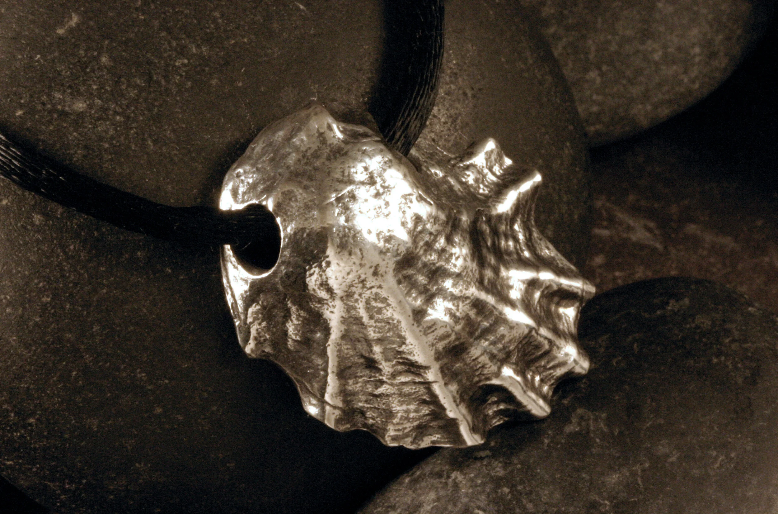 Right side view of large vertical oxidized sterling silver Wellfleet oyster seashell slide pendant.