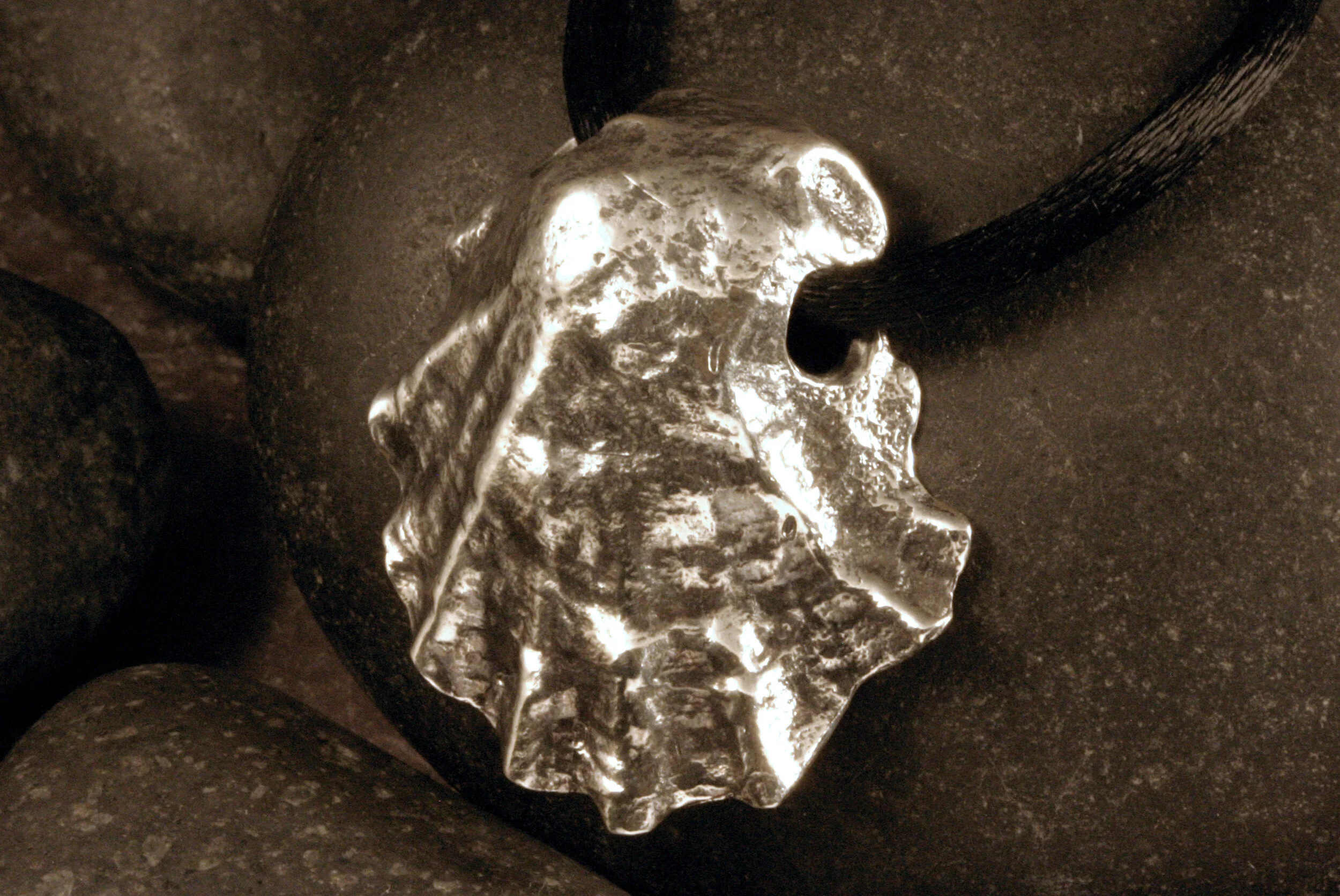 Left side view of large vertical oxidized sterling silver Wellfleet oyster seashell slide pendant.