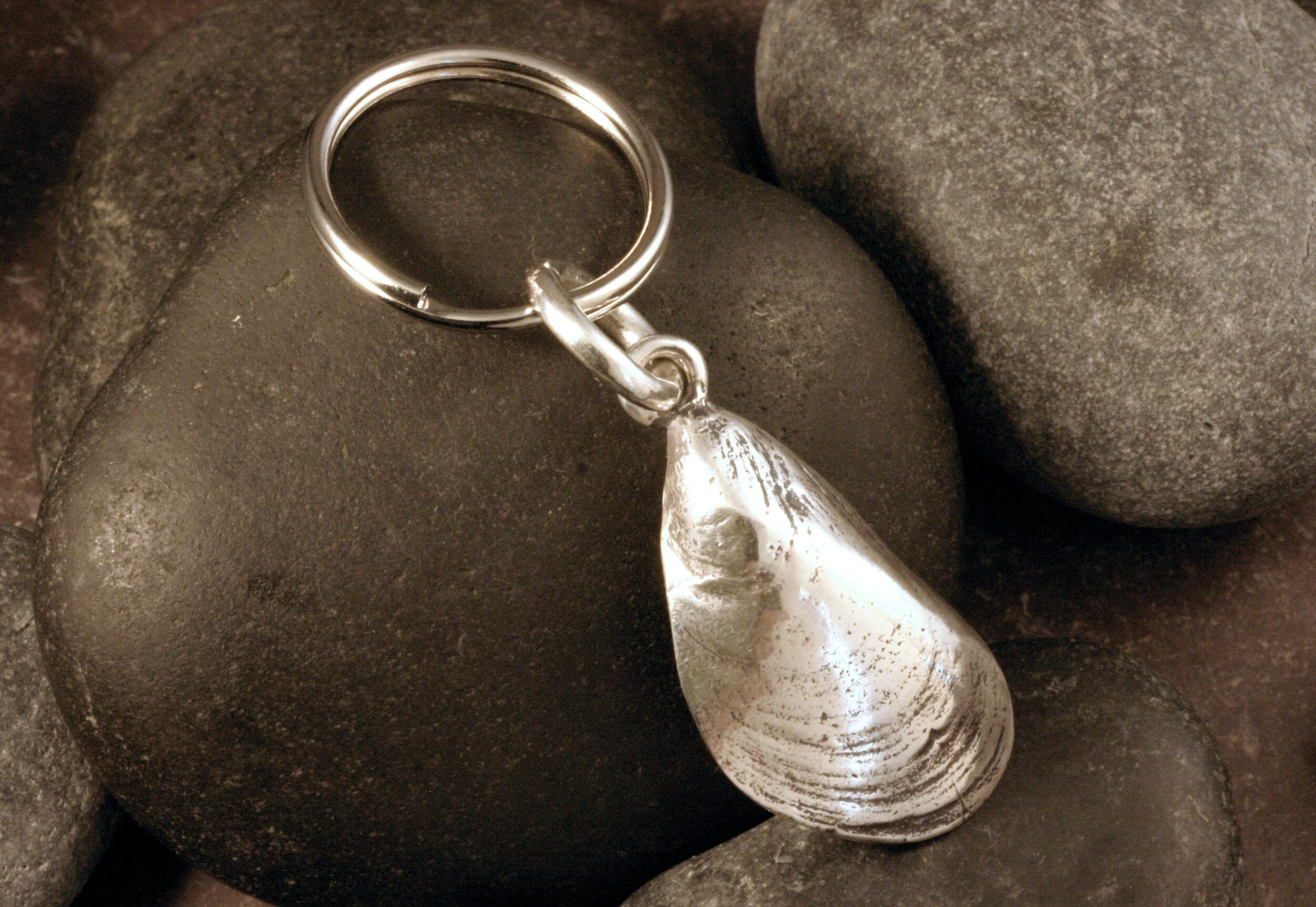 Oxidized sterling silver mussel seashell keychain with a nickel plated key ring.