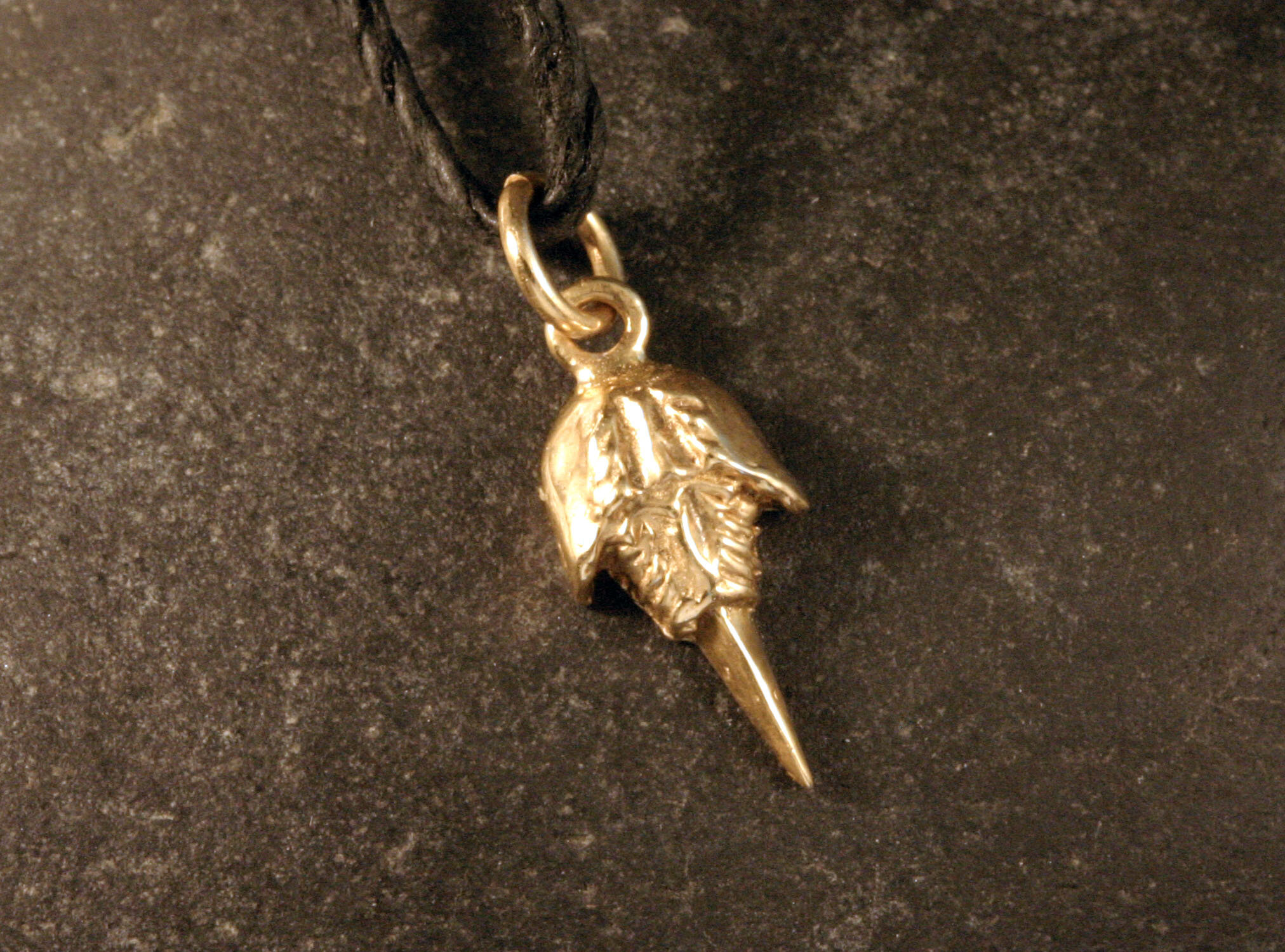 A 14K gold mini horseshoe crab charm