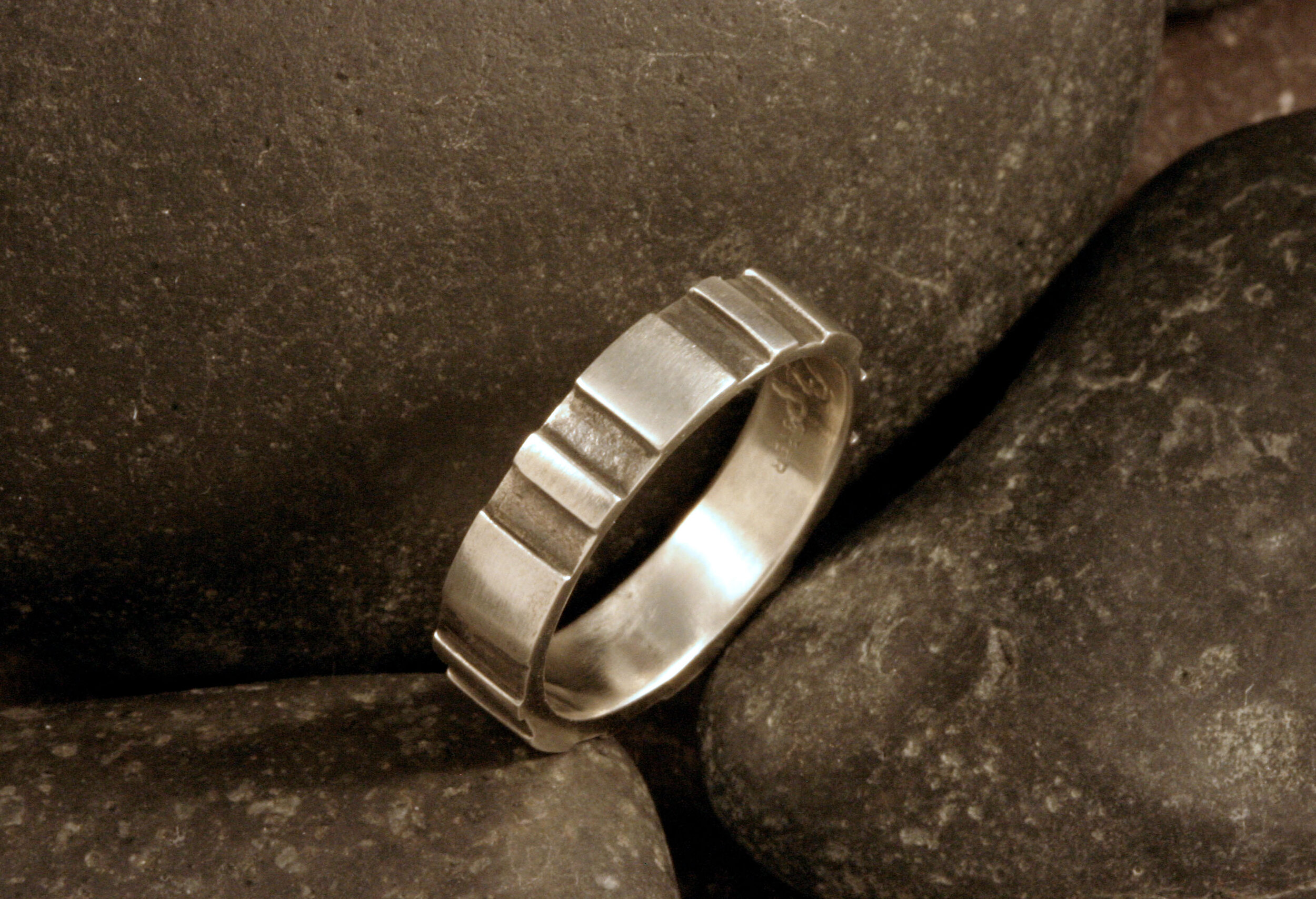 Narrow oxidized sterling silver gear ring band.