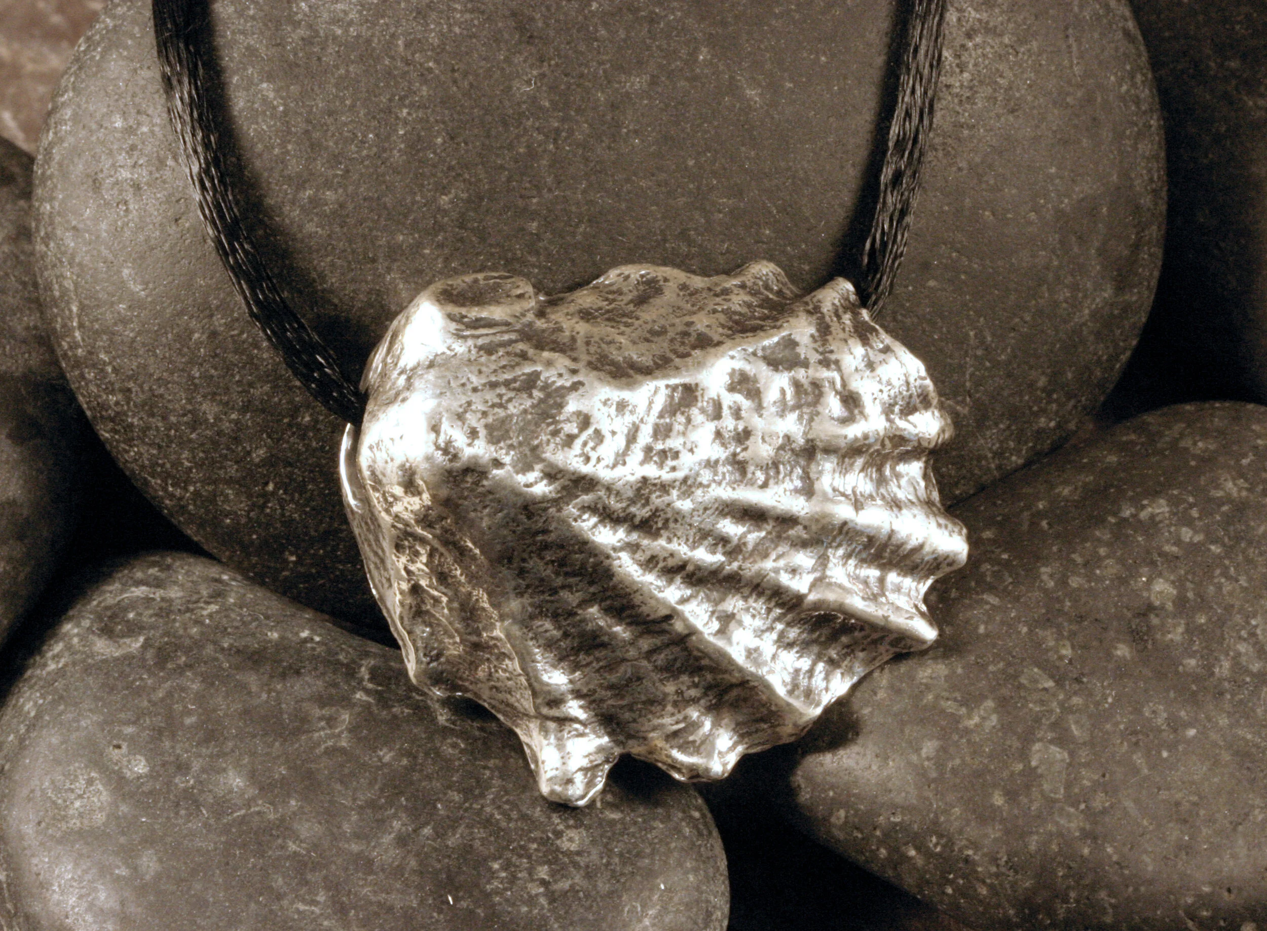 Large oxidized sterling silver Wellfleet oyster seashell slide pendant on black cord.
