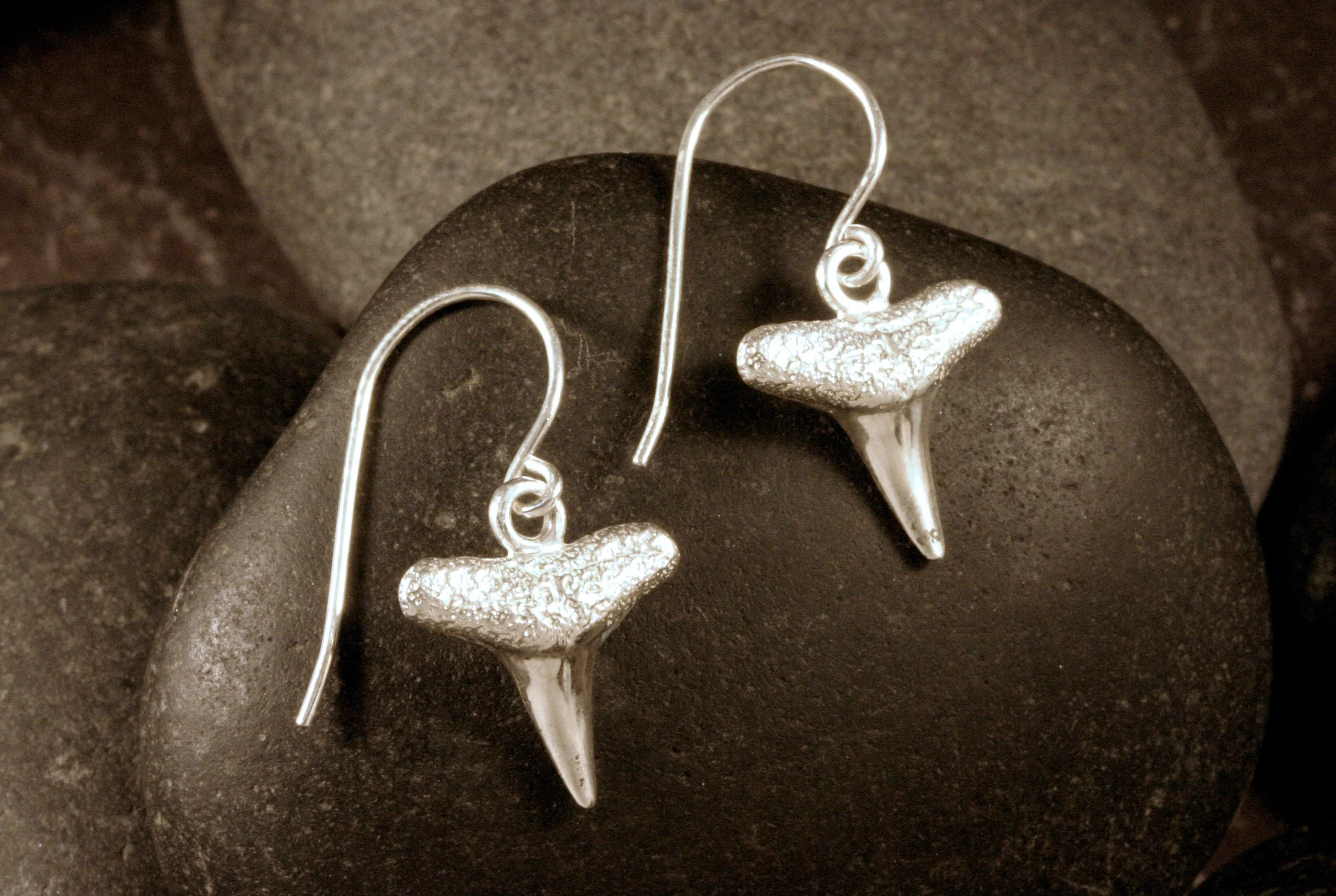 Sterling silver shark teeth dangle earrings.
